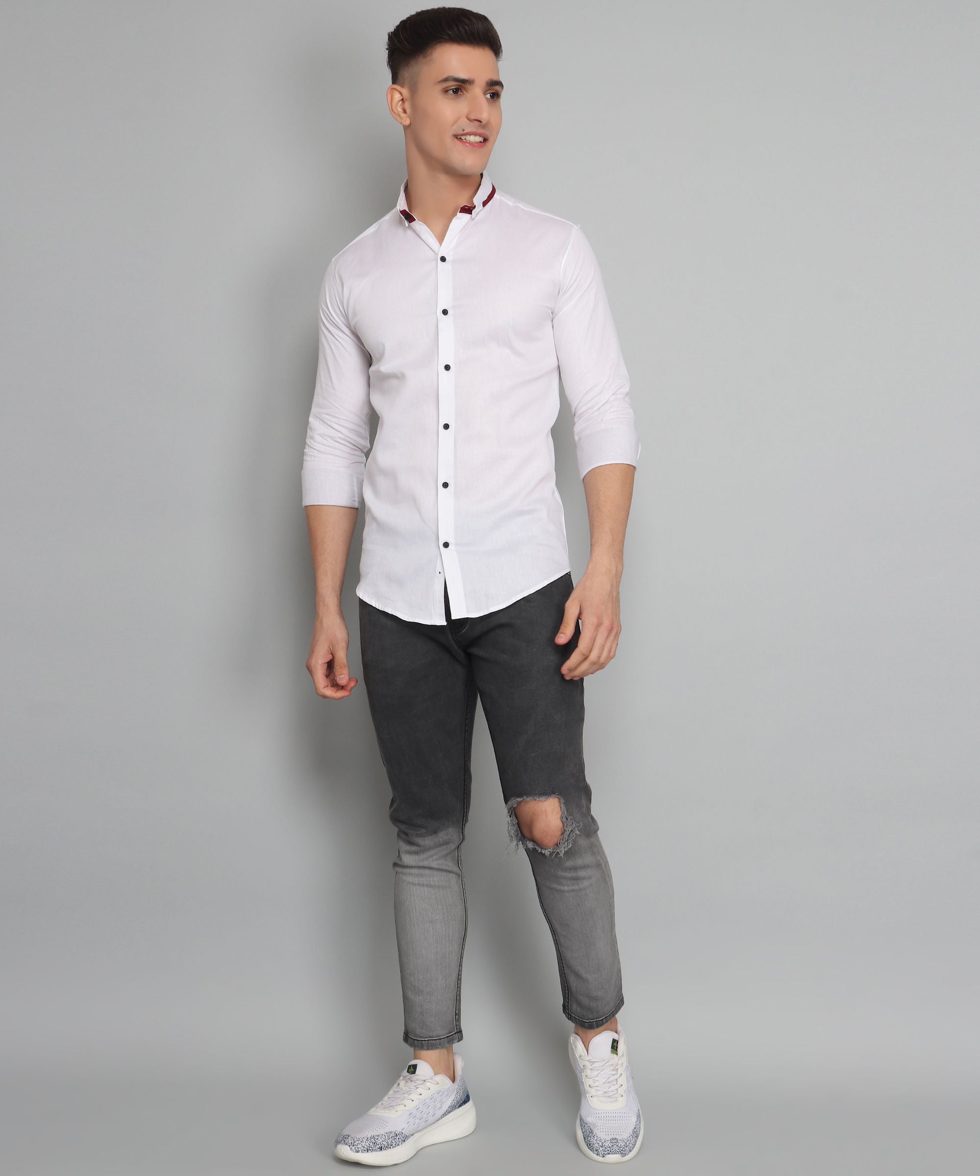 a man in a white shirt and black jeans