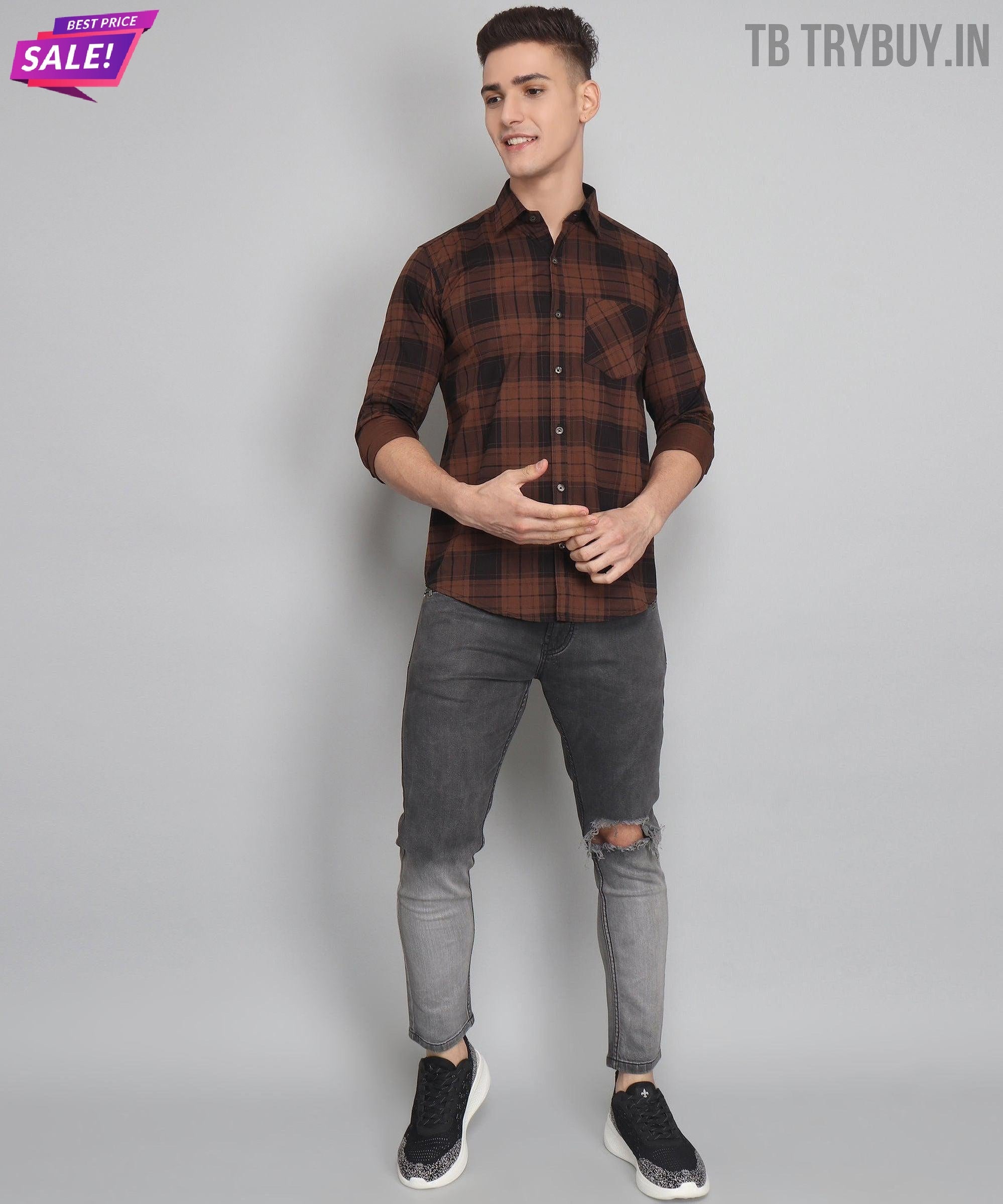 a man in a plaid shirt and jeans posing for a picture