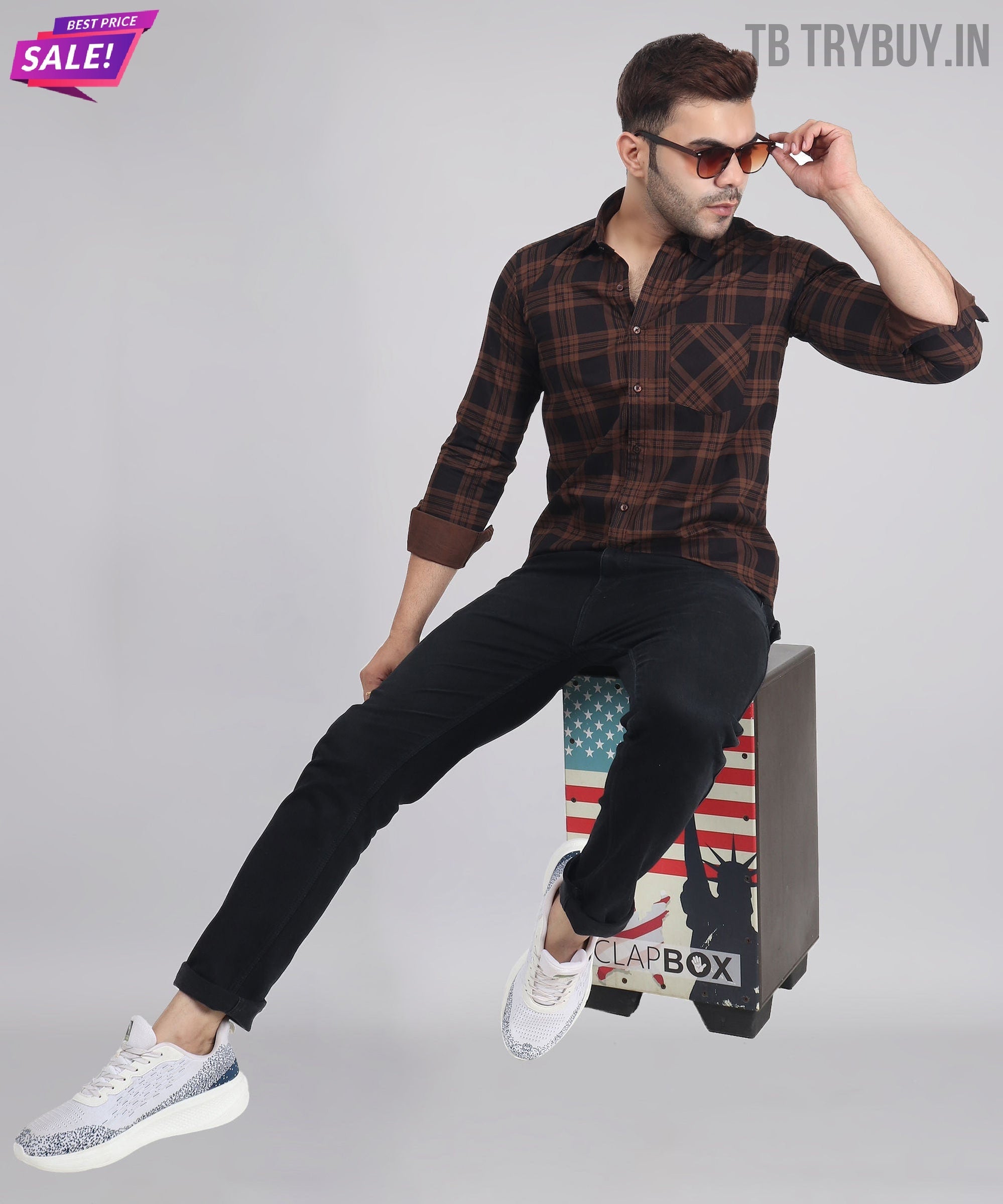 a man sitting on top of a box with a skateboard