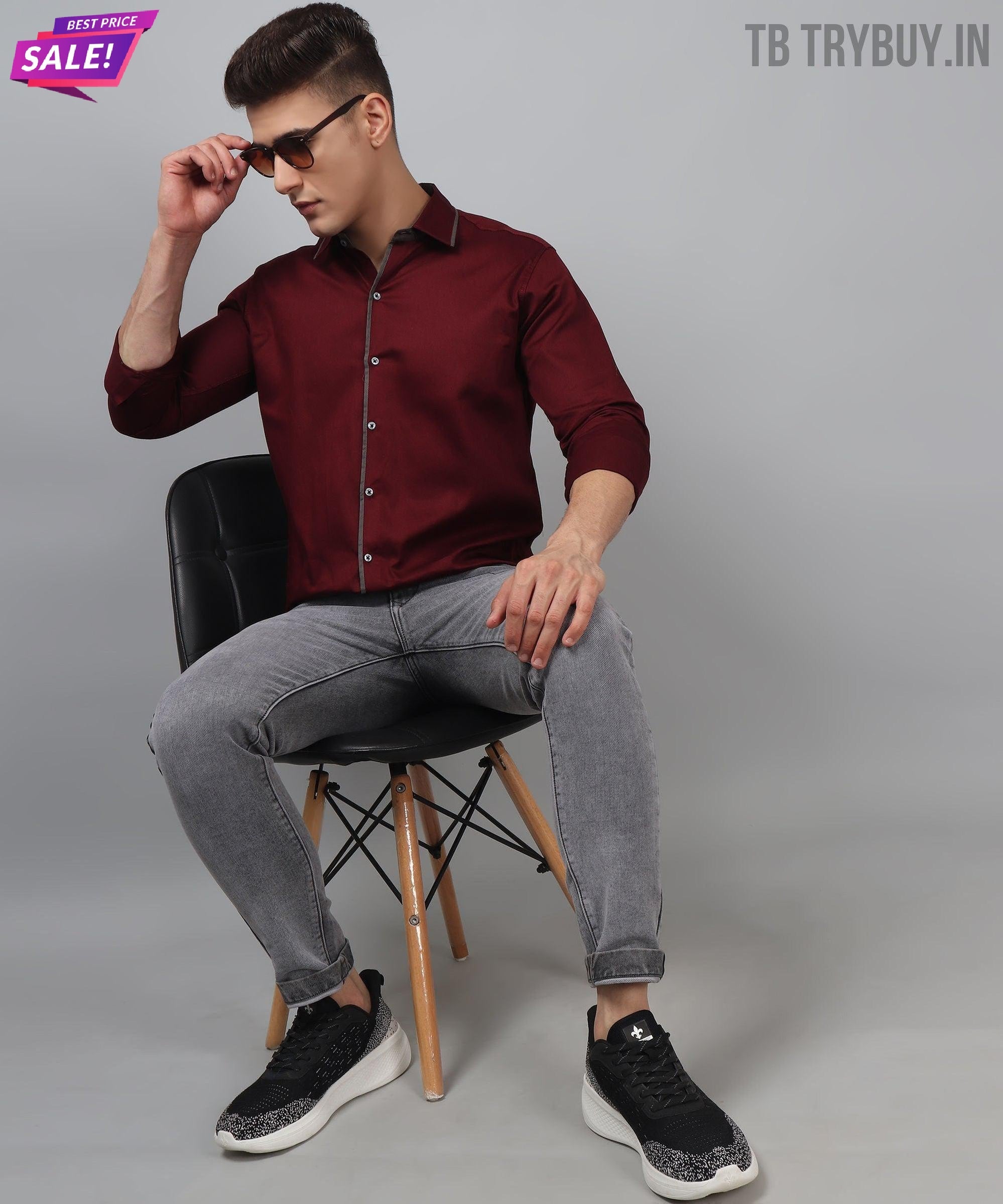 a man sitting on a chair wearing a red shirt