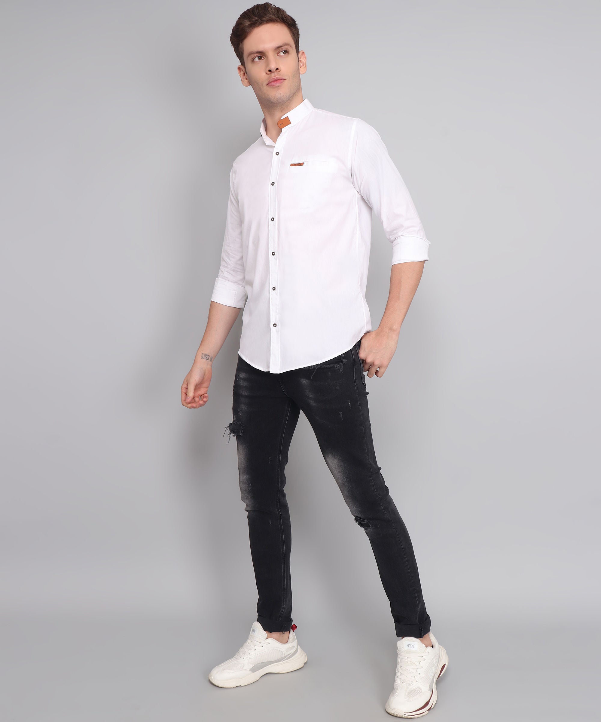 a man in a white shirt and black pants