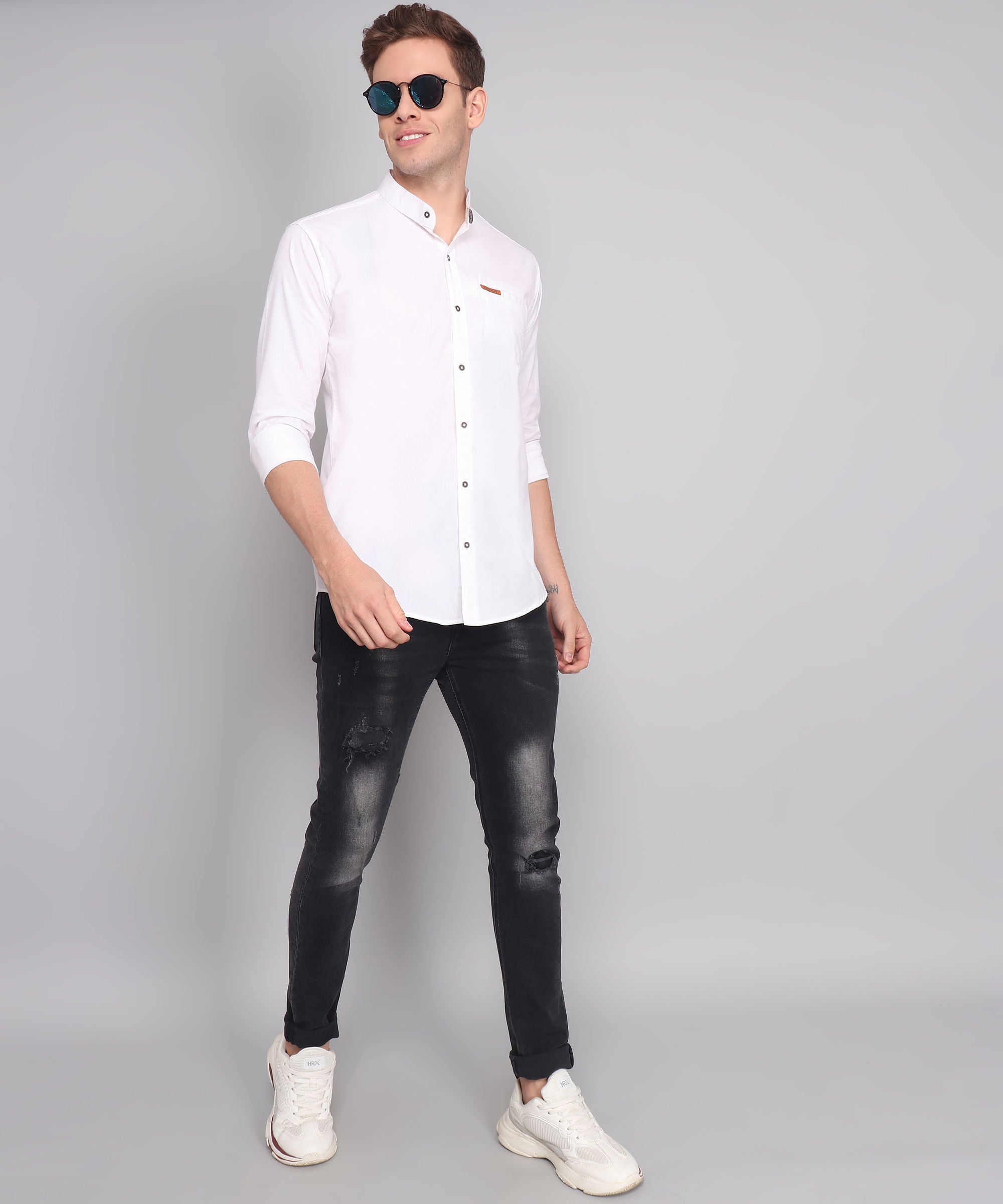 a man wearing a white shirt and black jeans