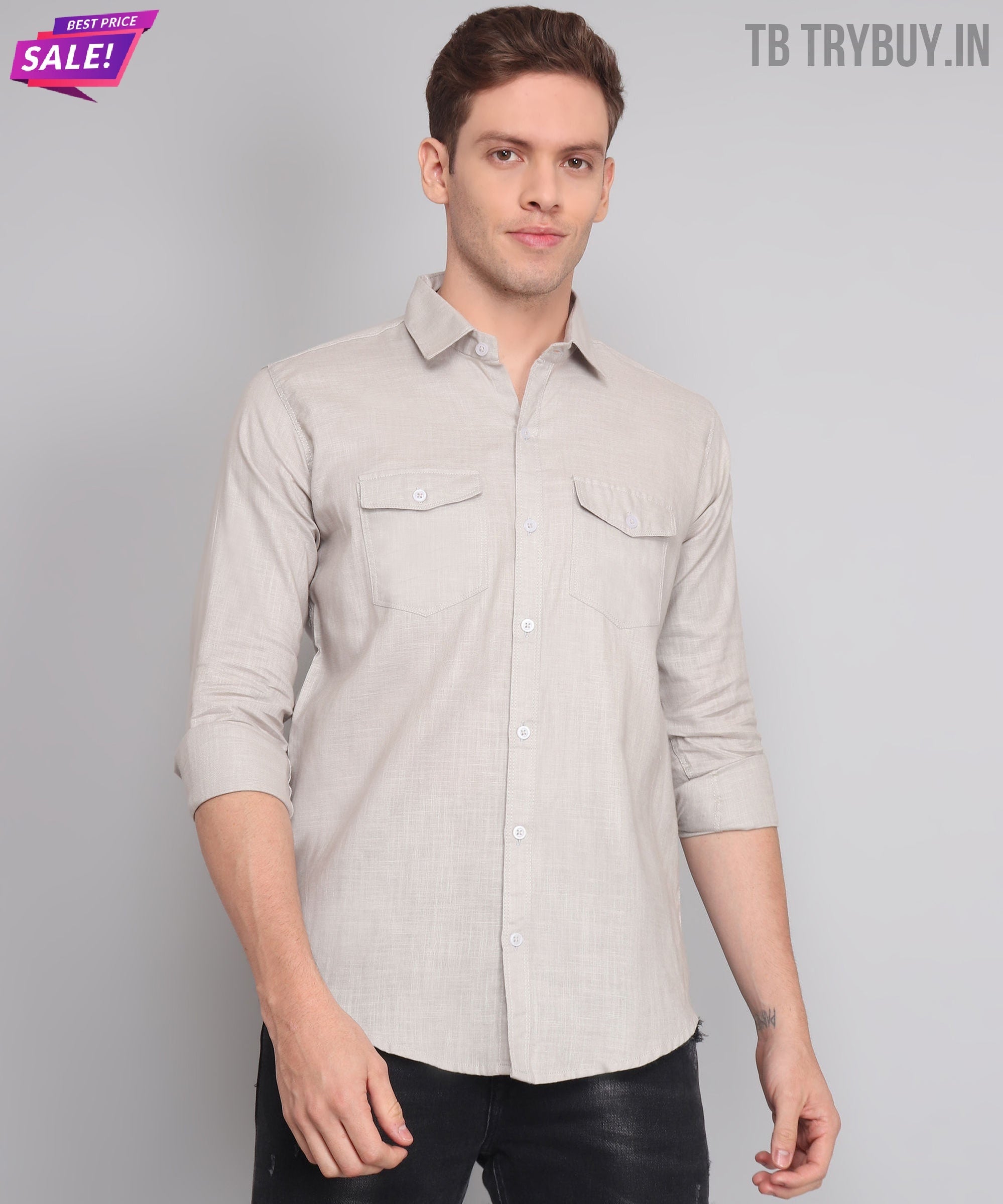 a man in a gray shirt is posing for a picture