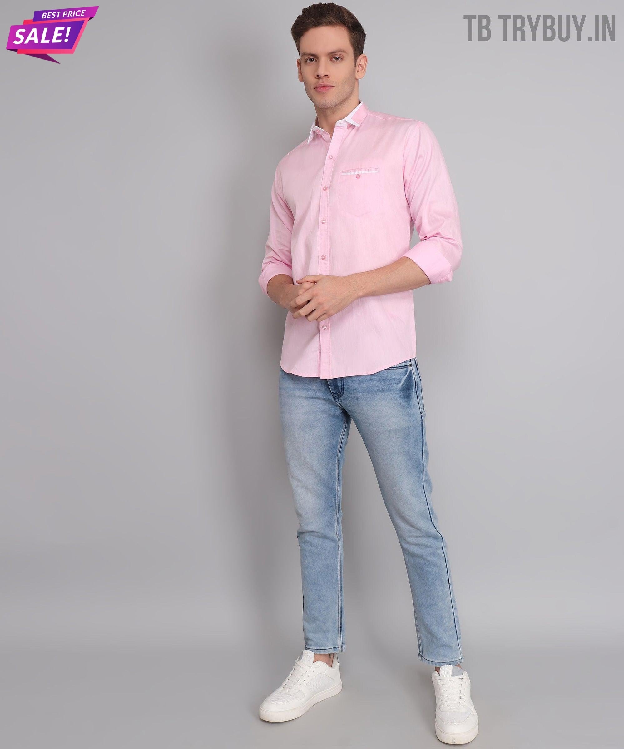 a man in a pink shirt and jeans