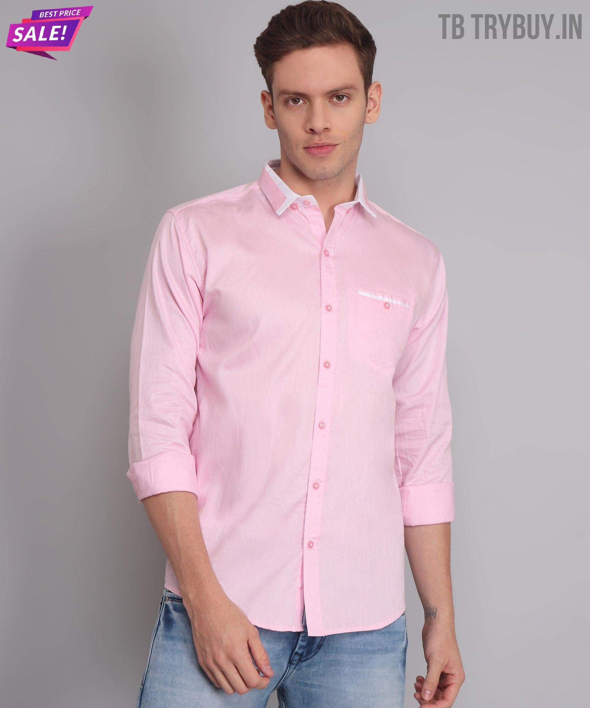 a man wearing a pink shirt and jeans