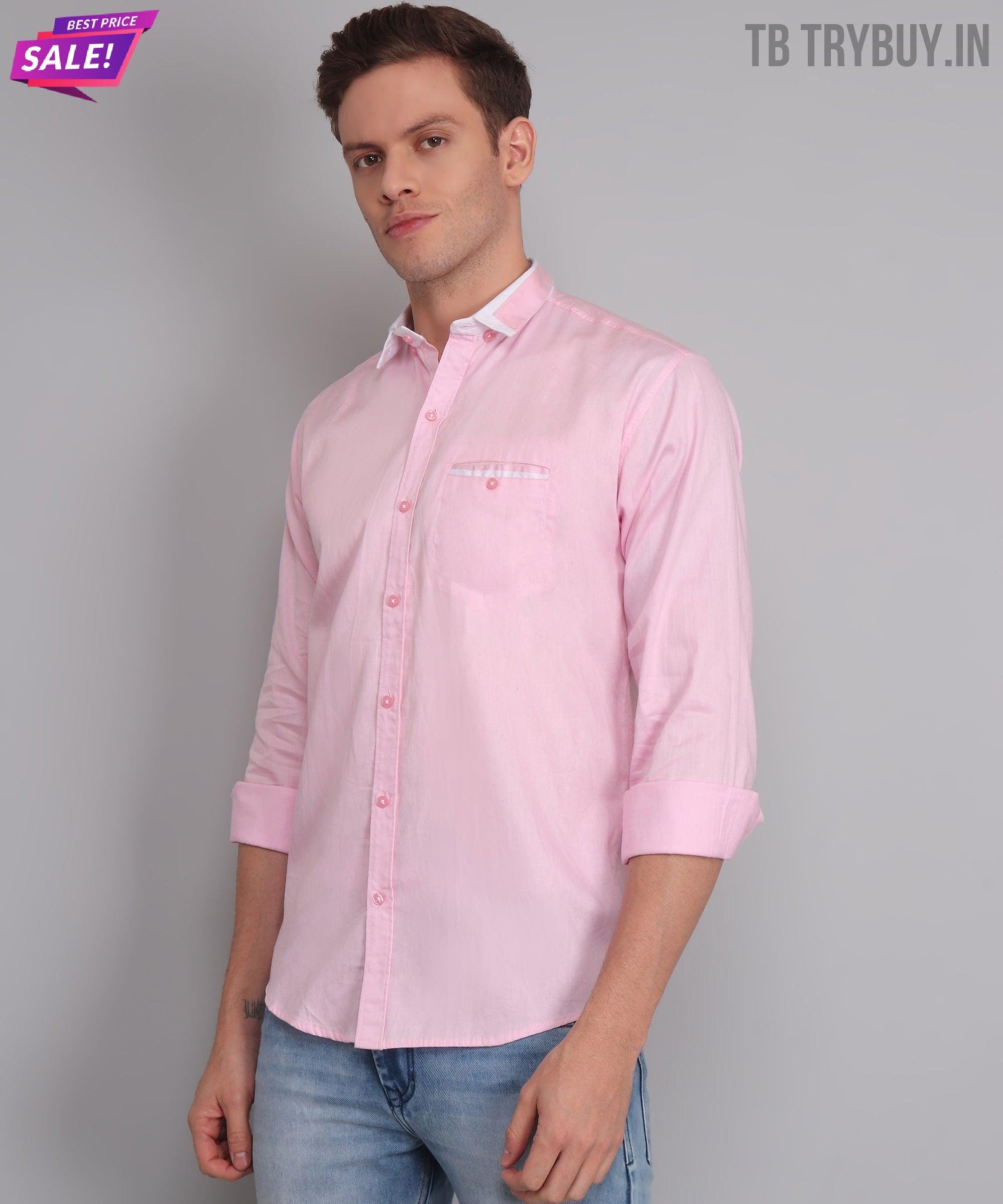 a man wearing a pink shirt and jeans