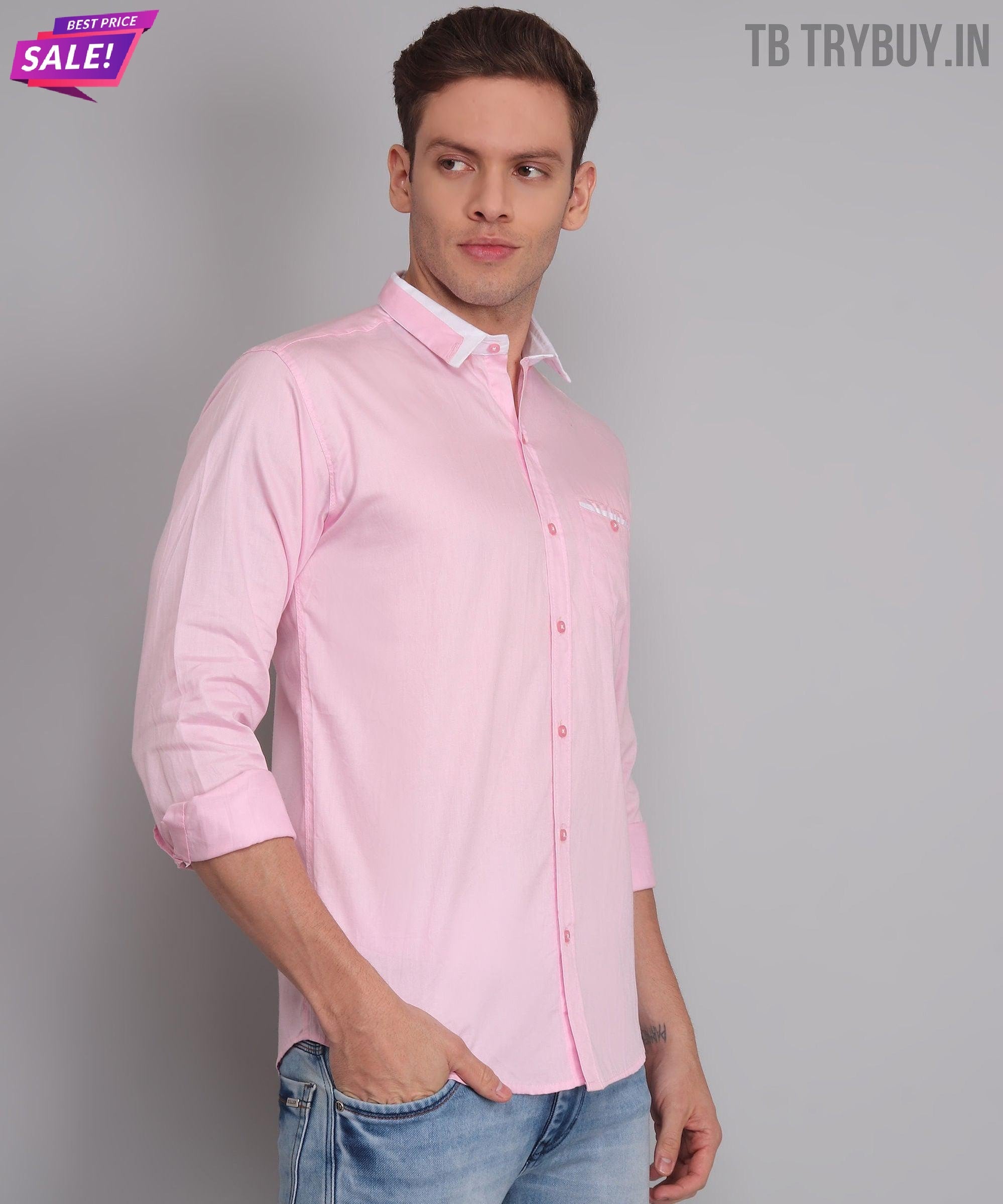 a man wearing a pink shirt and jeans