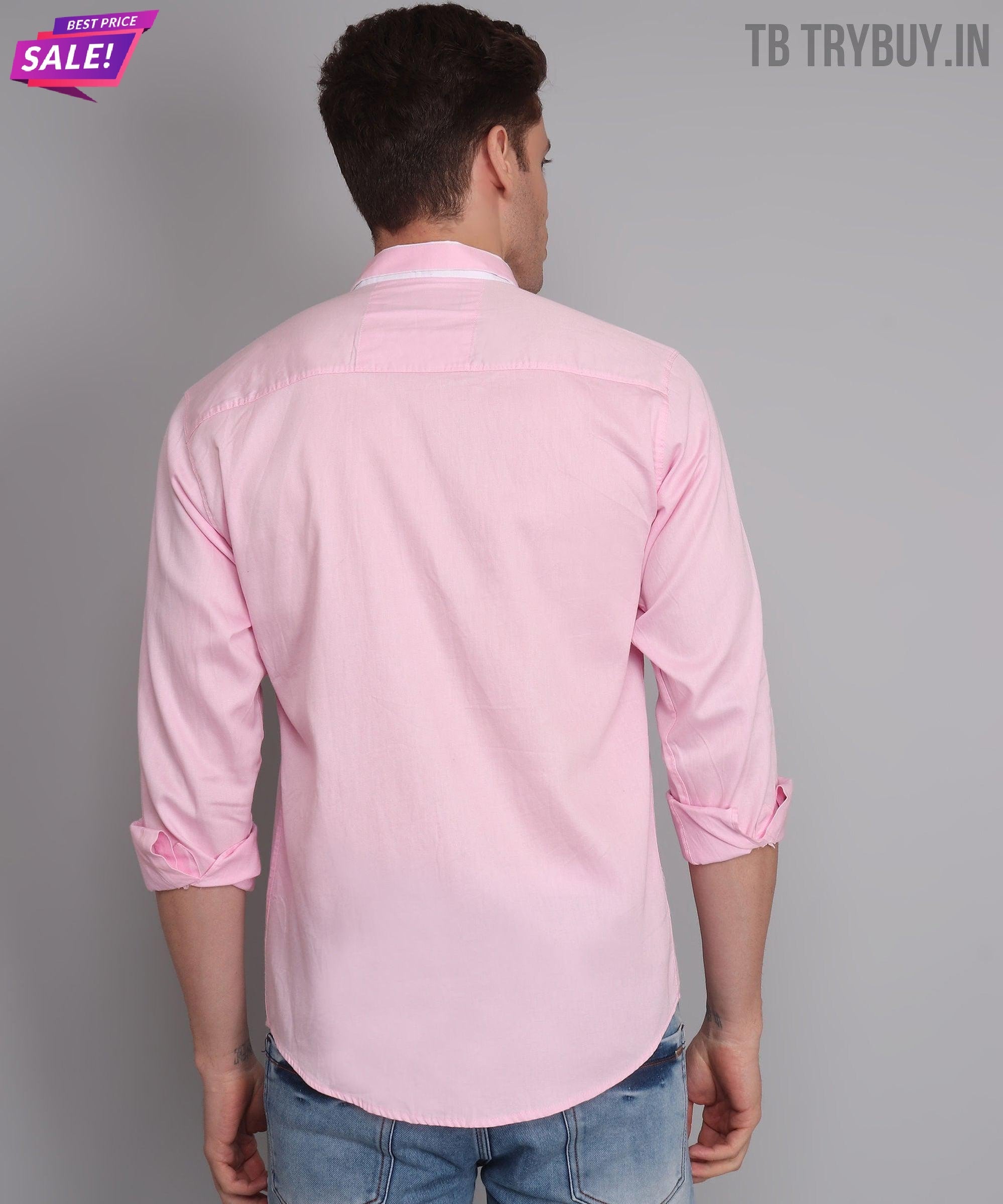 a man wearing a pink shirt and jeans