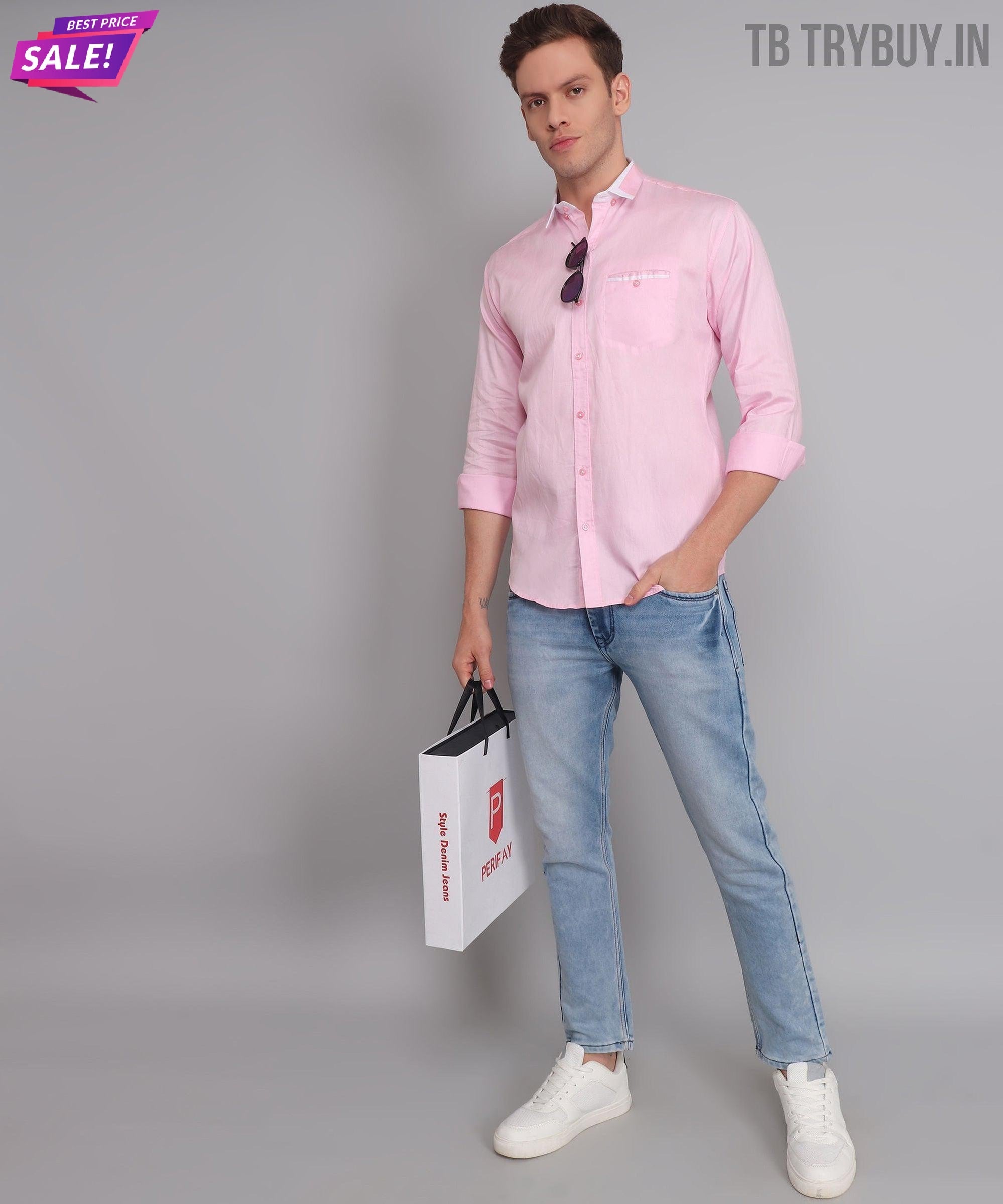 a man in a pink shirt holding a white bag