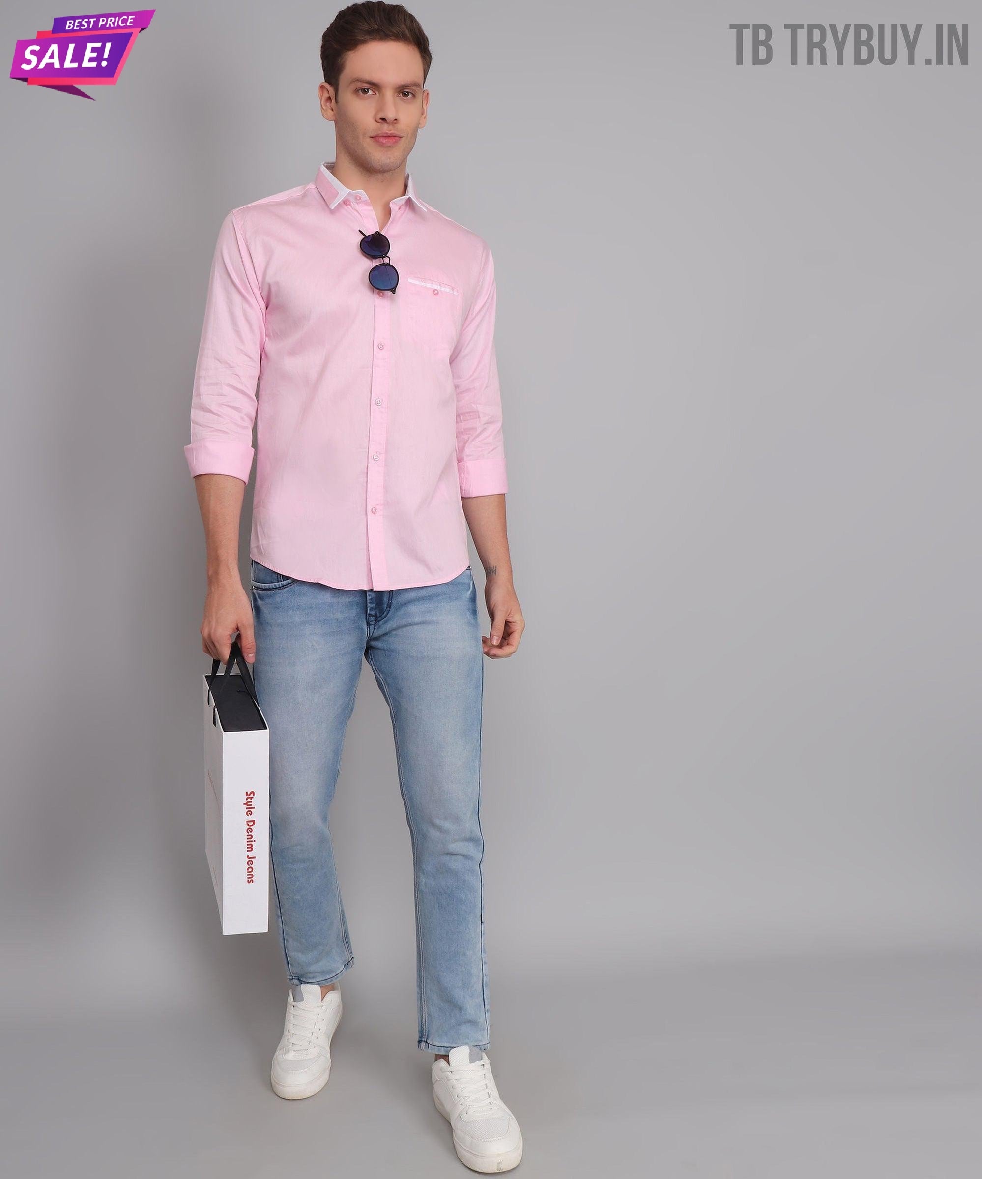 a man in a pink shirt holding a white bag