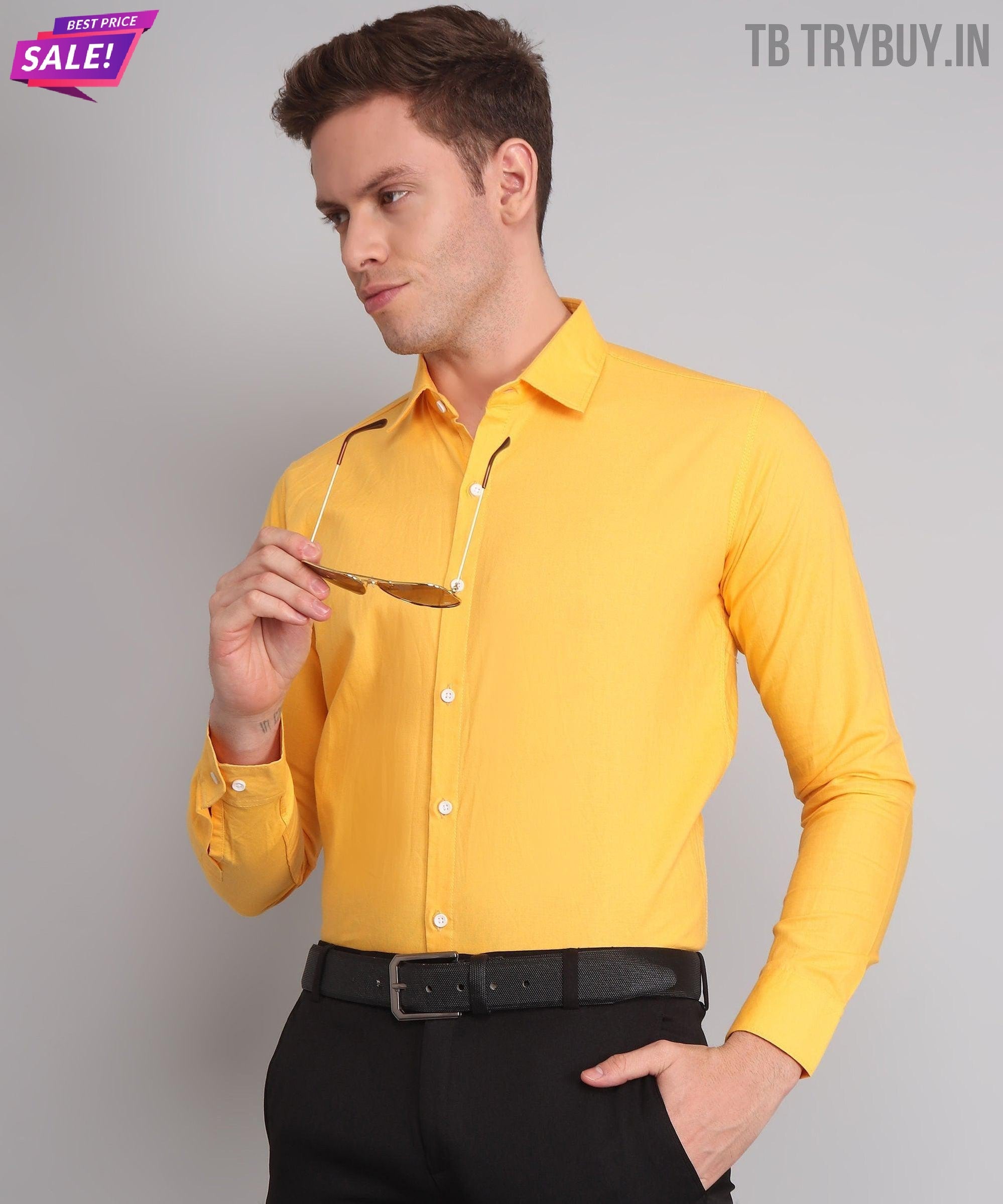 a man wearing a yellow shirt and black pants