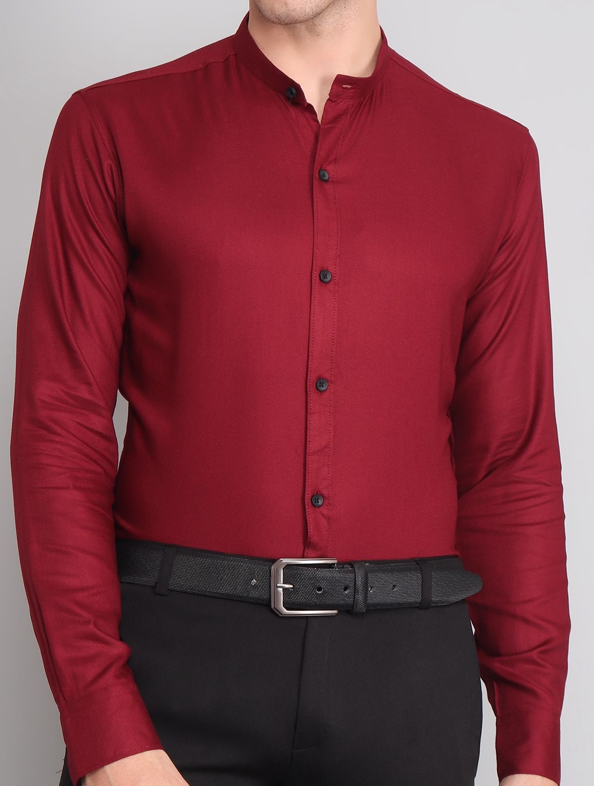 a man wearing a red shirt and black pants