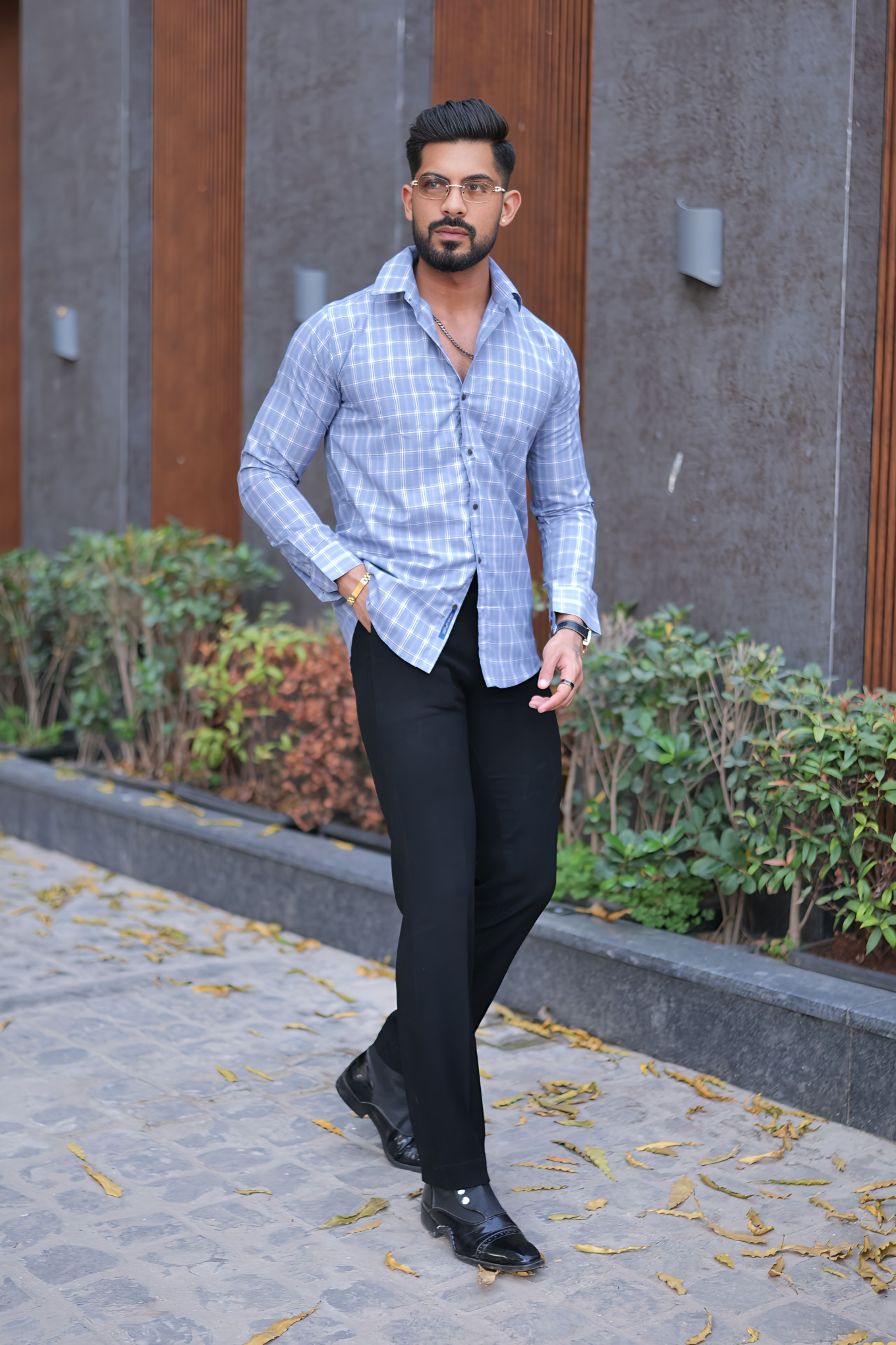 a man in a blue shirt and black pants