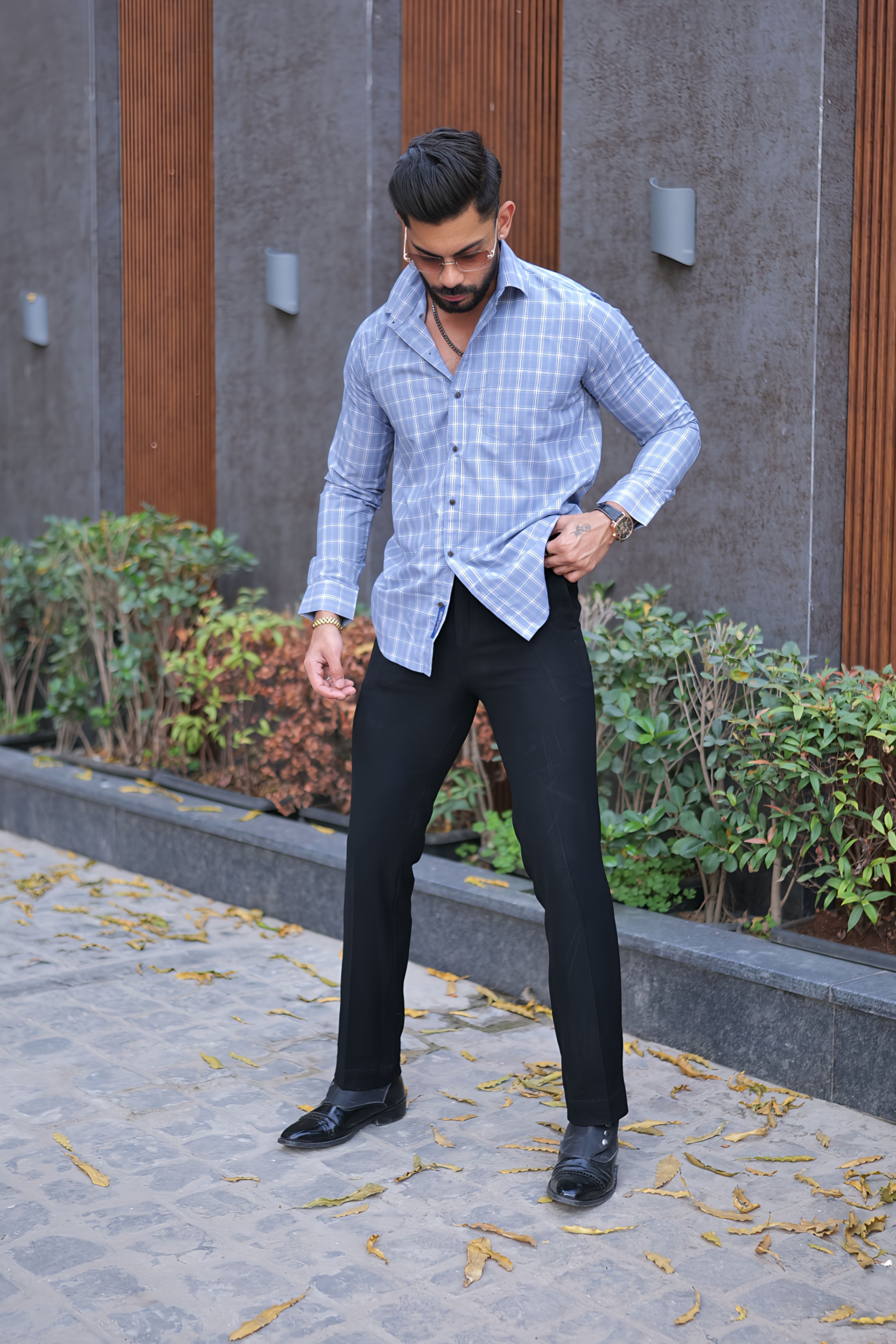 a man in a blue shirt and black pants