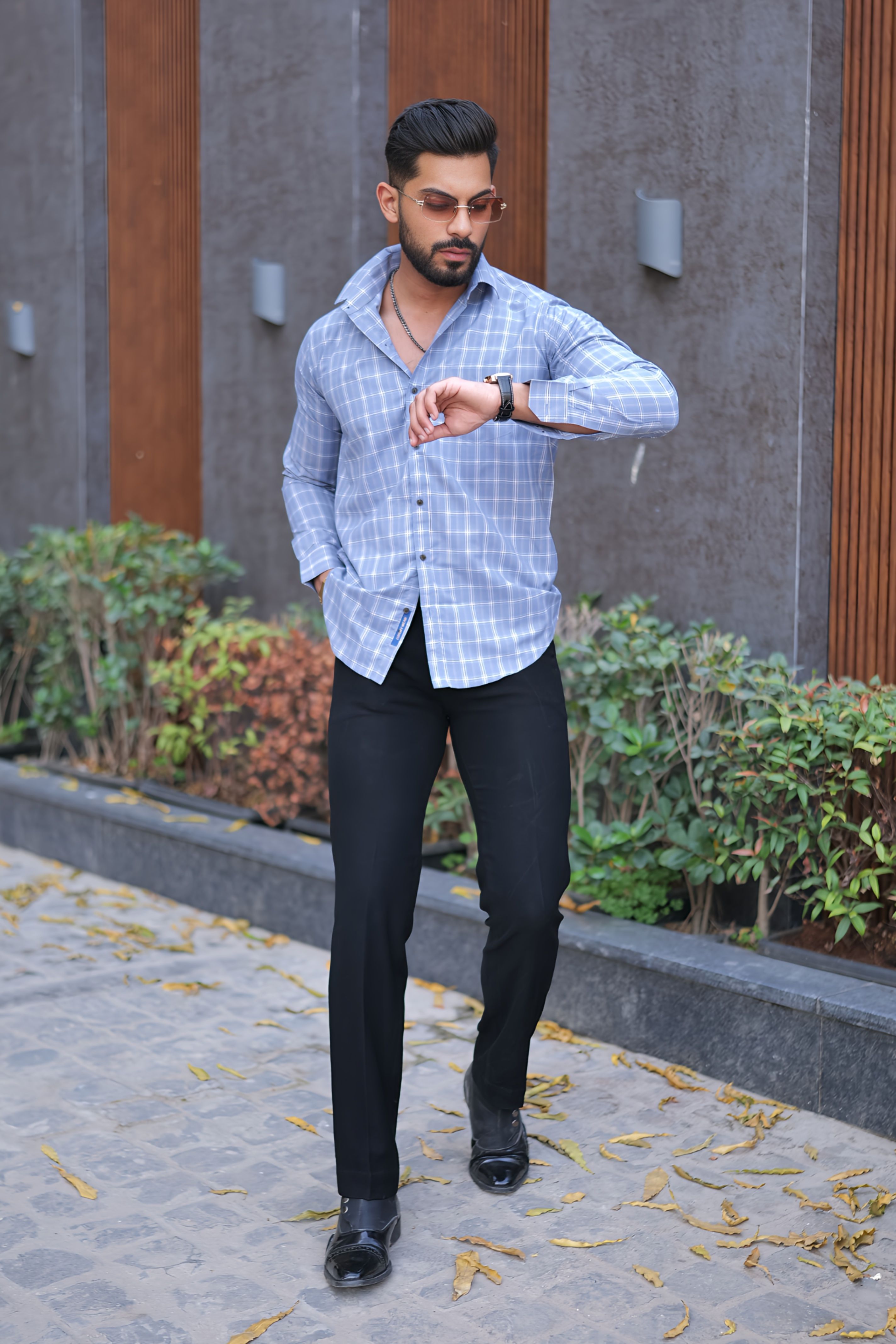 a man in a blue shirt and black pants