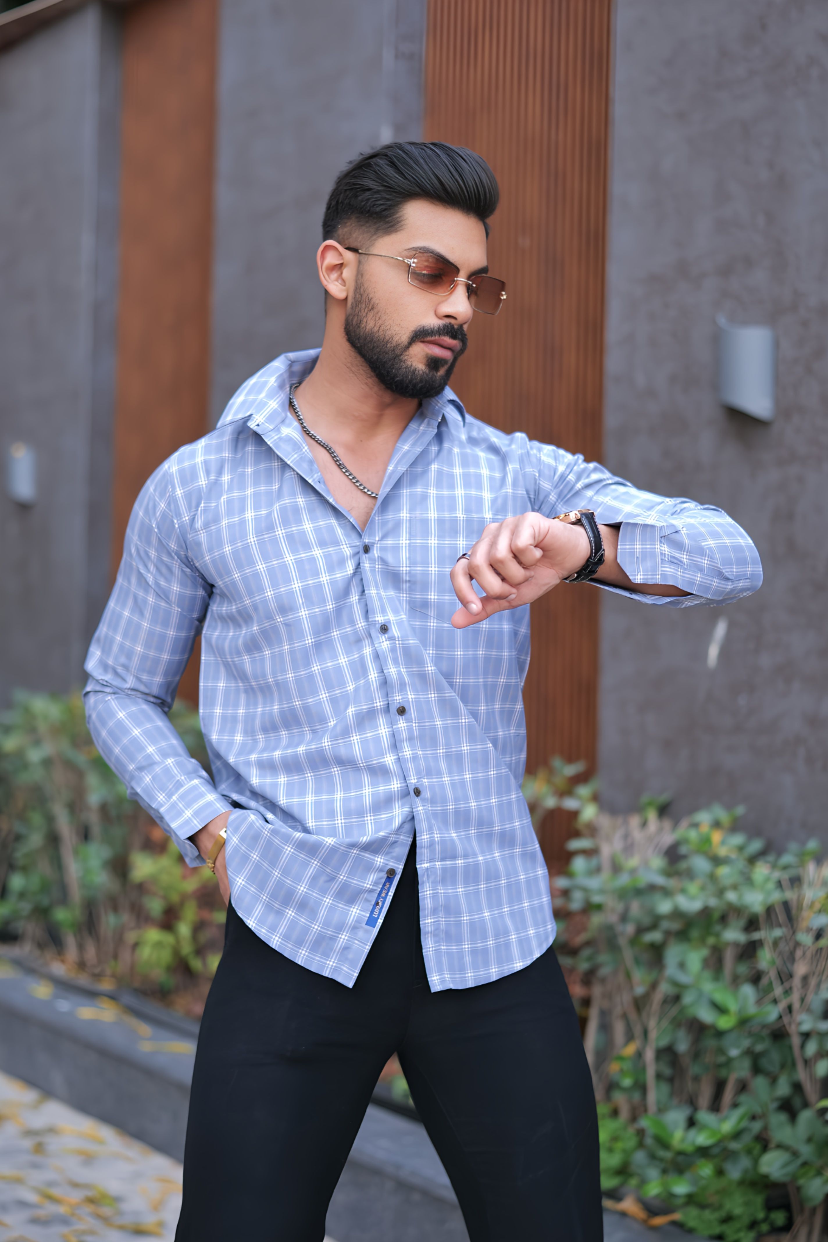 a man in a blue shirt and black pants