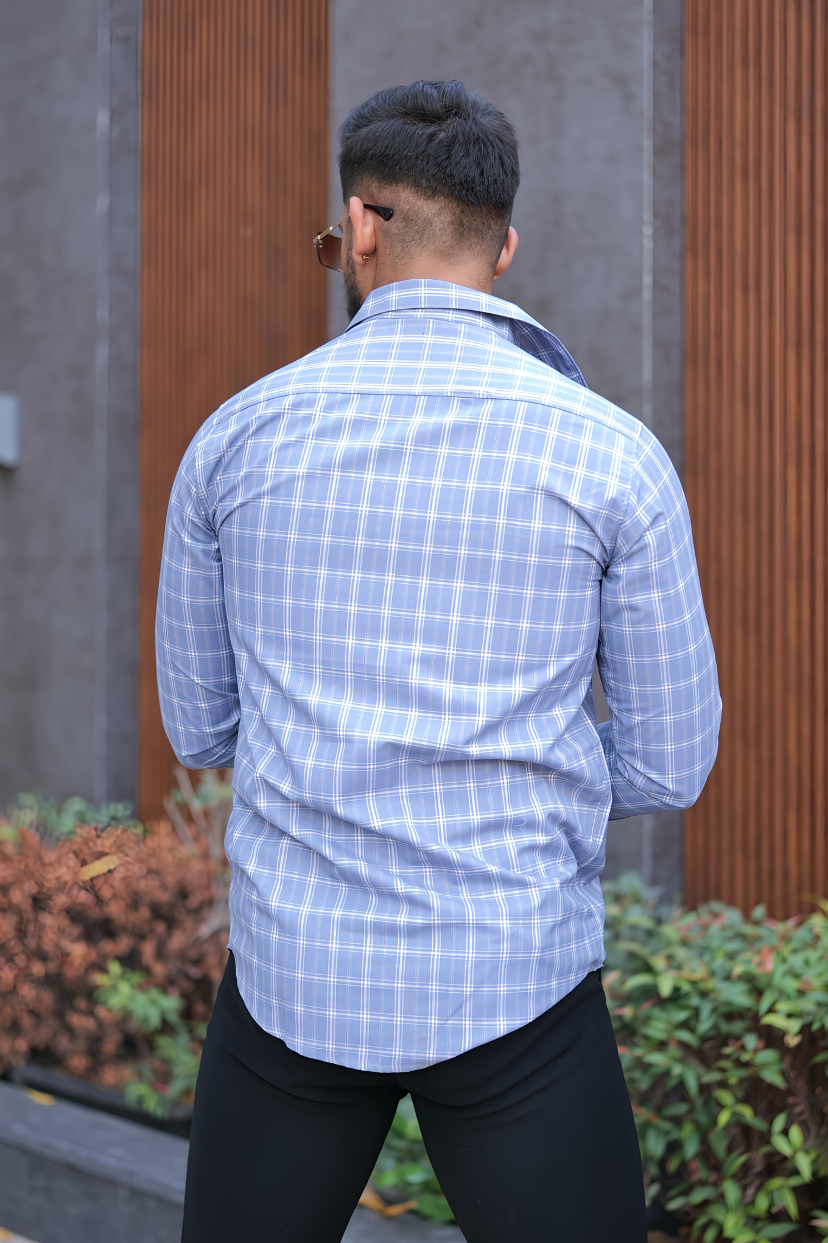 a man walking down a street with a cigarette in his mouth