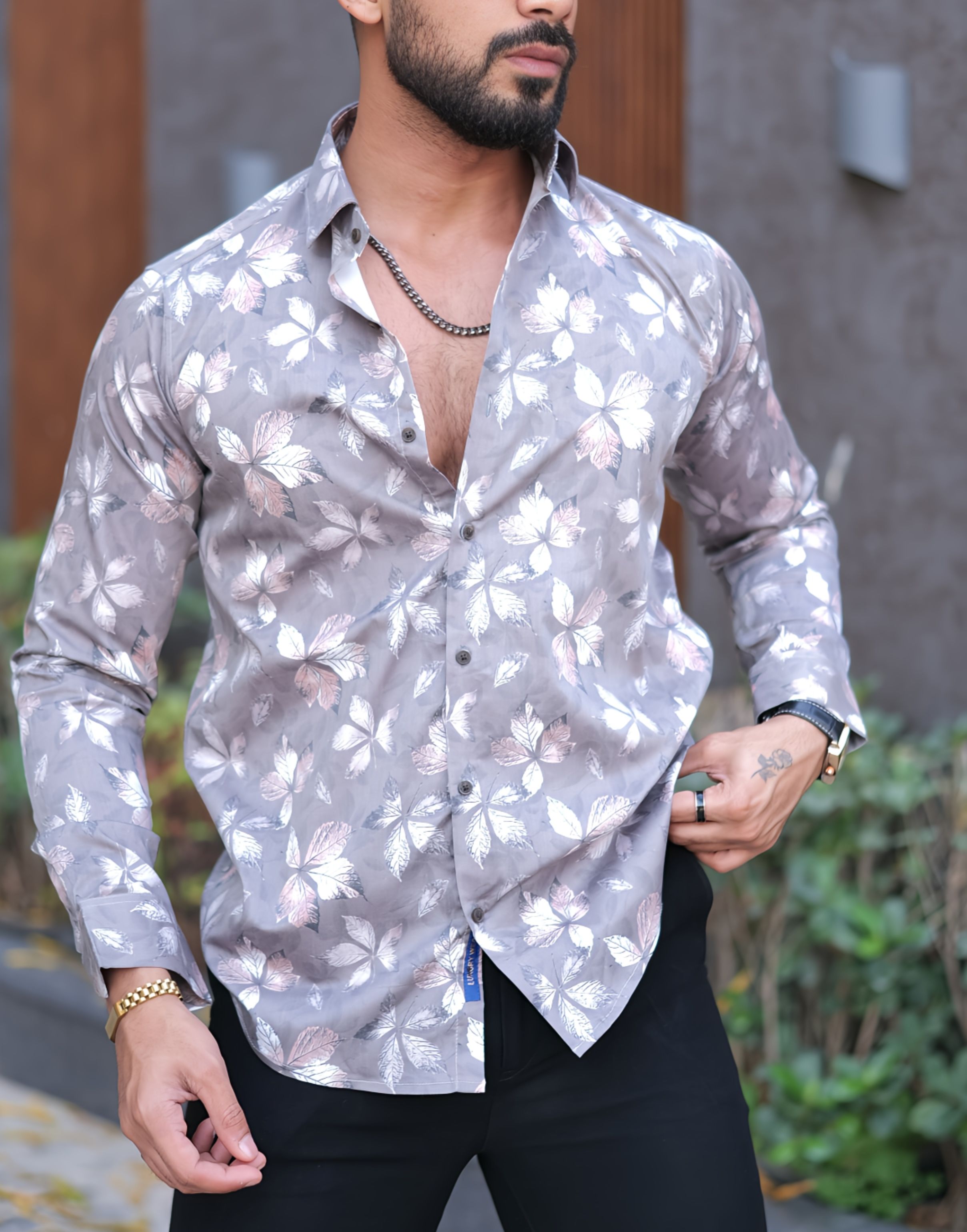 a man with a beard wearing a floral shirt