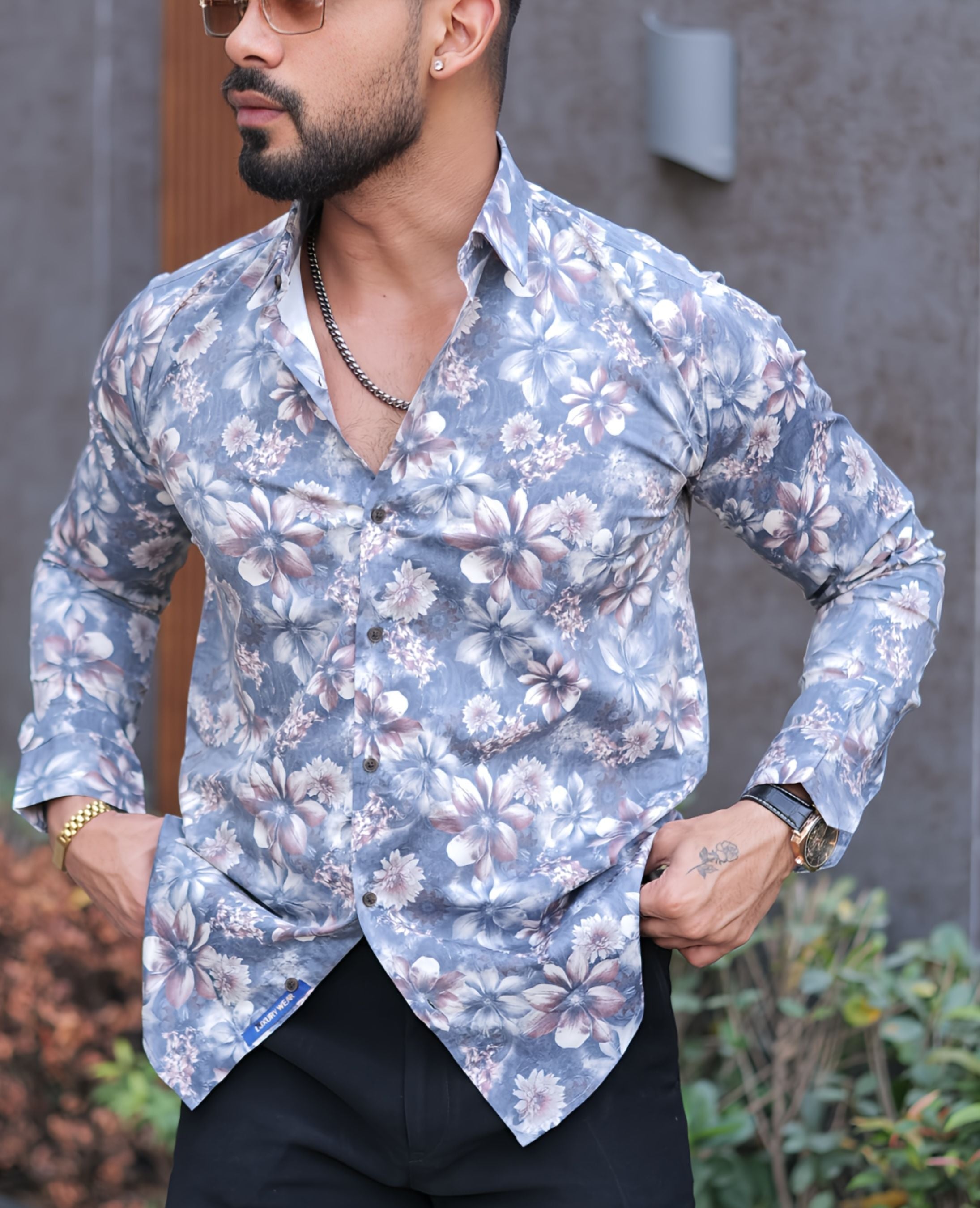 a man wearing a shirt with a flower pattern