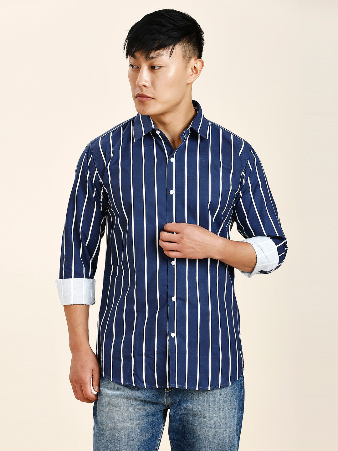 a man wearing a blue and white striped shirt