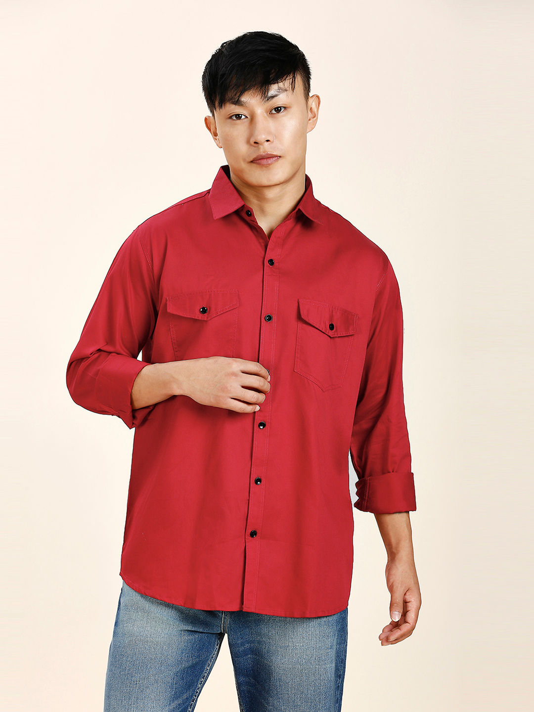 a man in a red shirt is posing for a picture