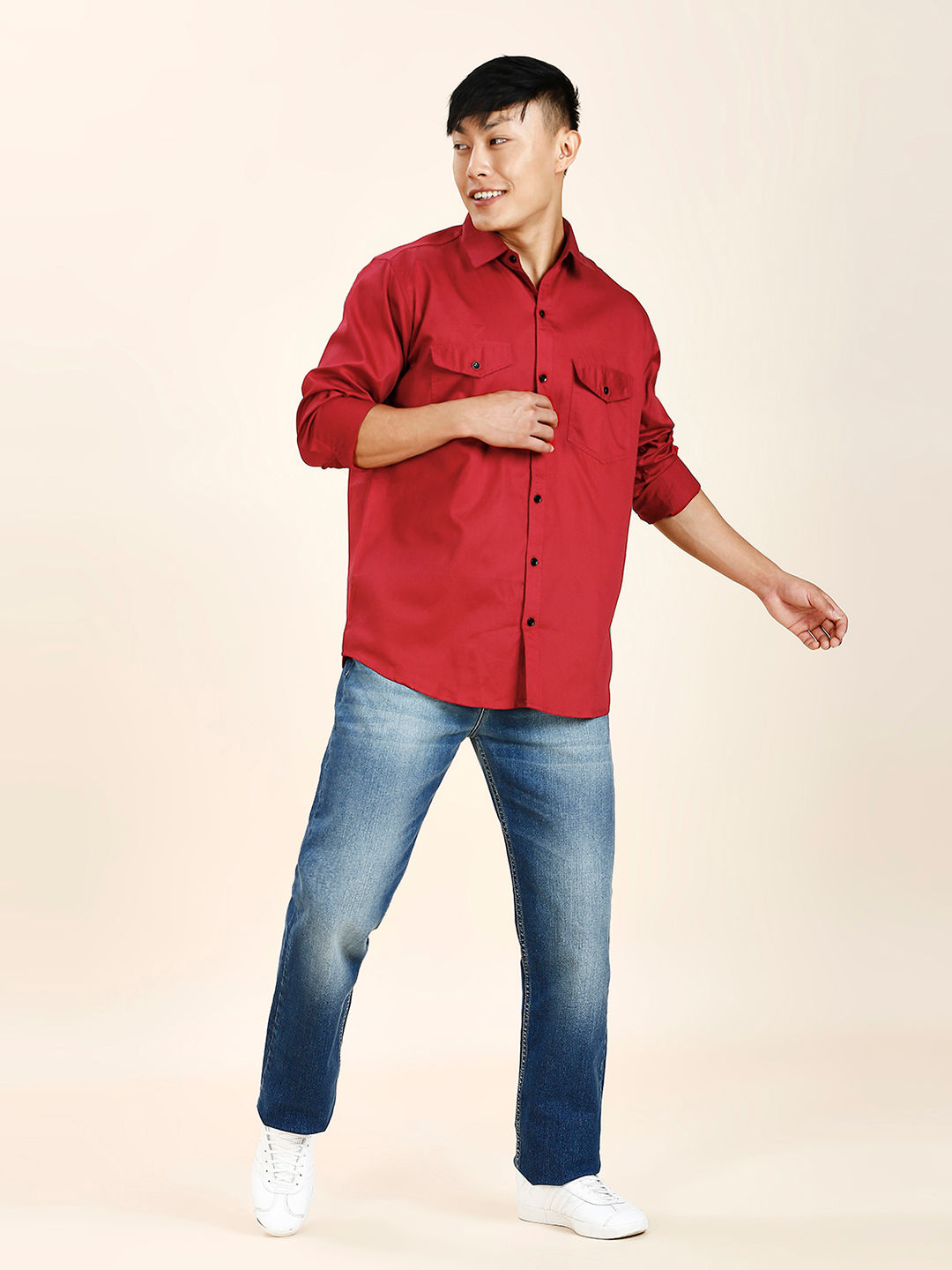 a man in a red shirt is posing for a picture