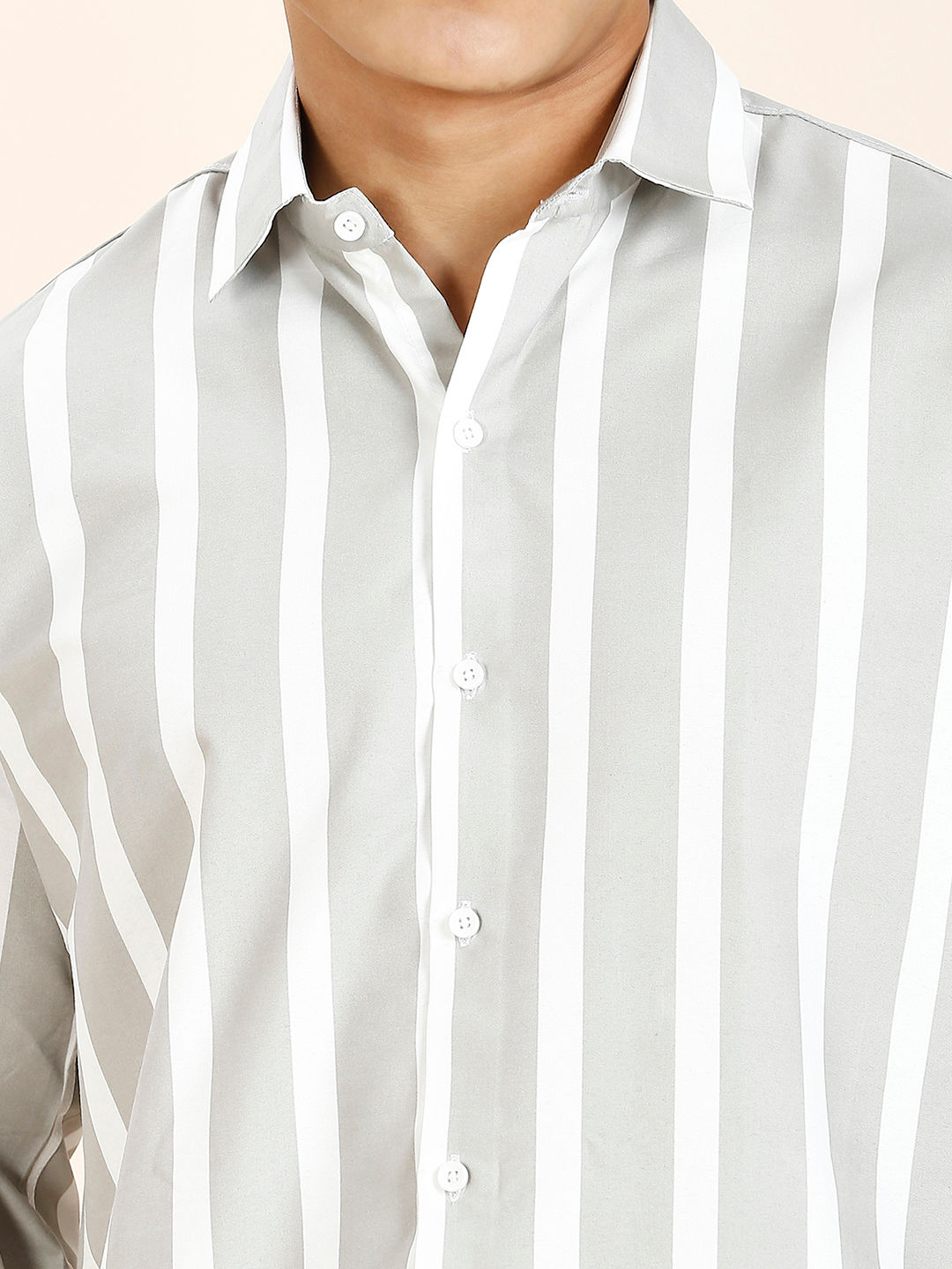 a close up of a person wearing a striped shirt