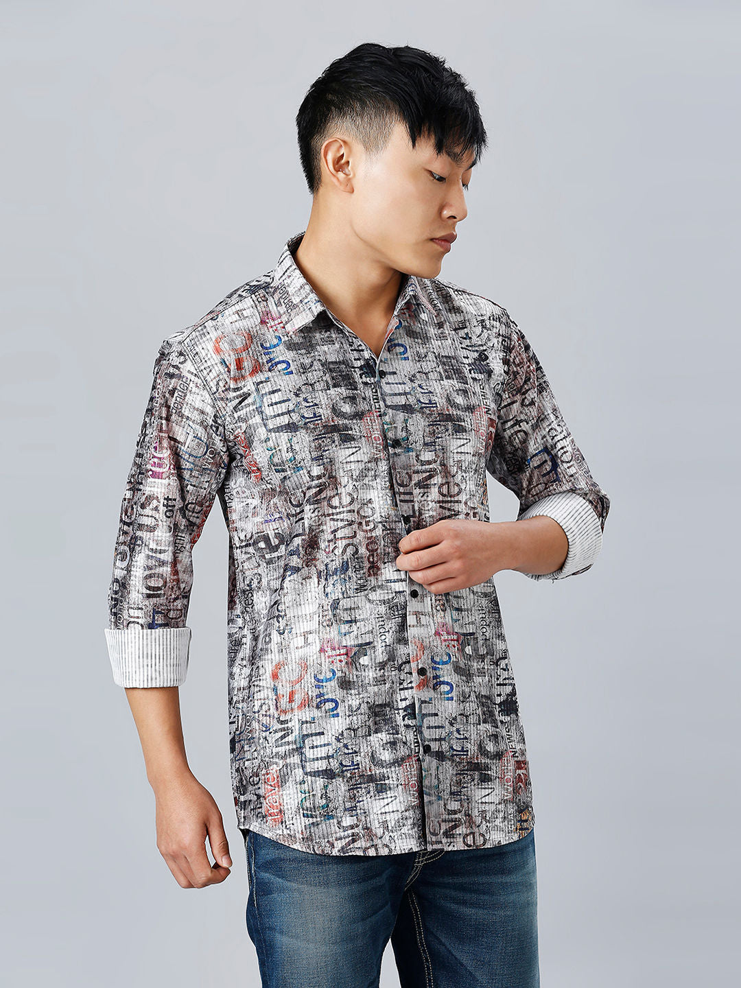 a young man wearing a shirt with a pattern on it