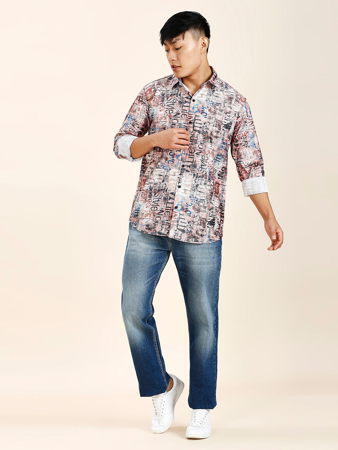 a man in a patterned shirt and jeans