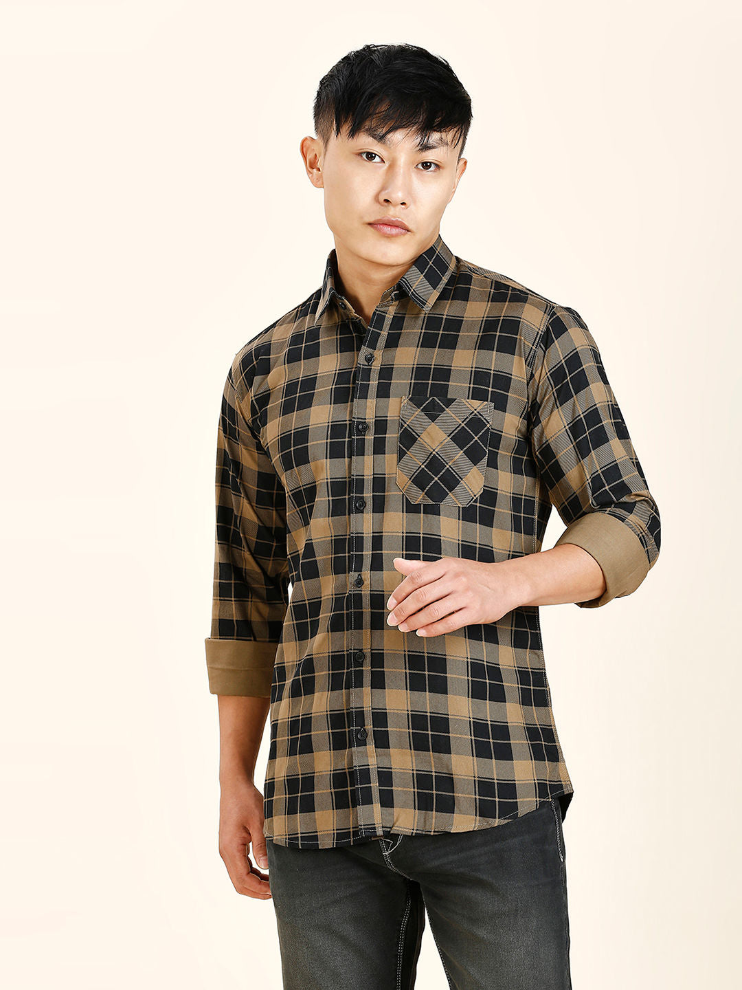 a man in a plaid shirt poses for a picture