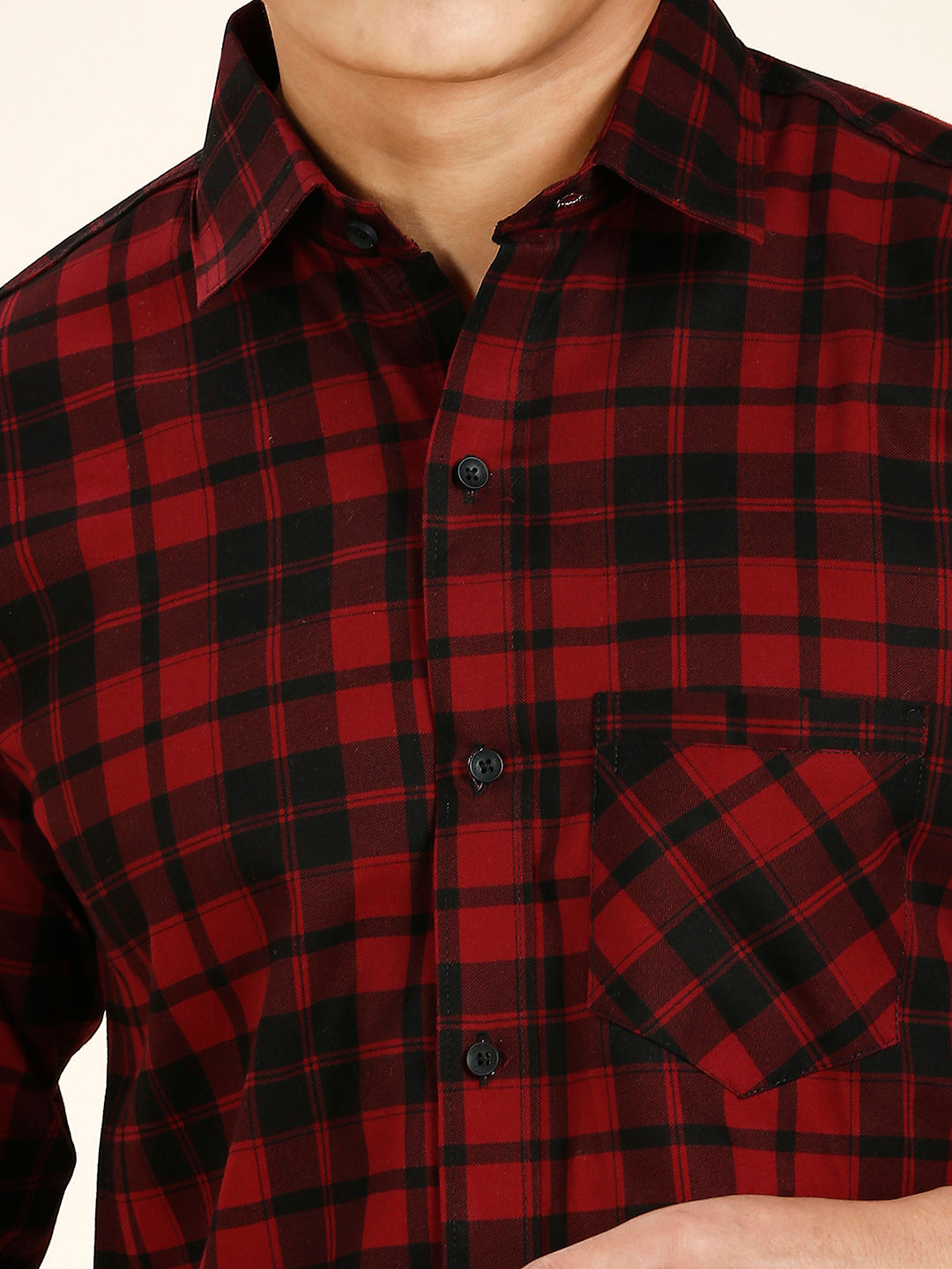 a man wearing a red and black plaid shirt