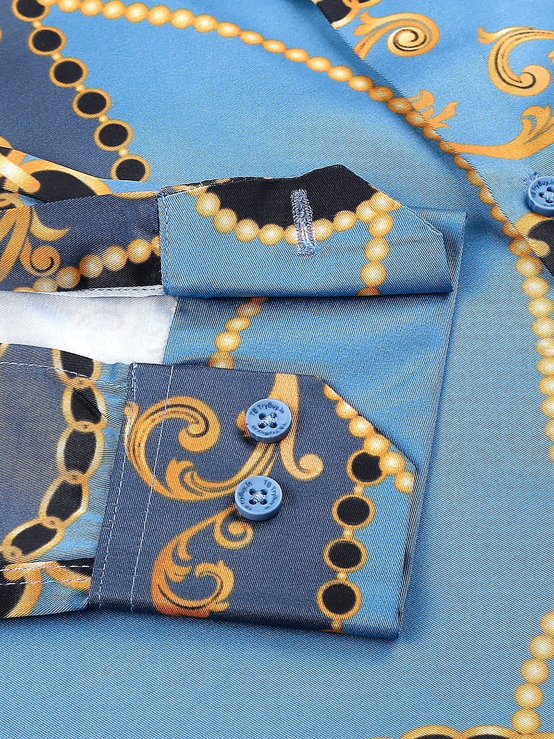 a close up of a blue and gold patterned shirt