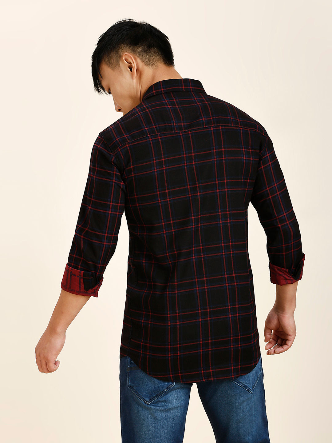 a man wearing a black and red checkered shirt