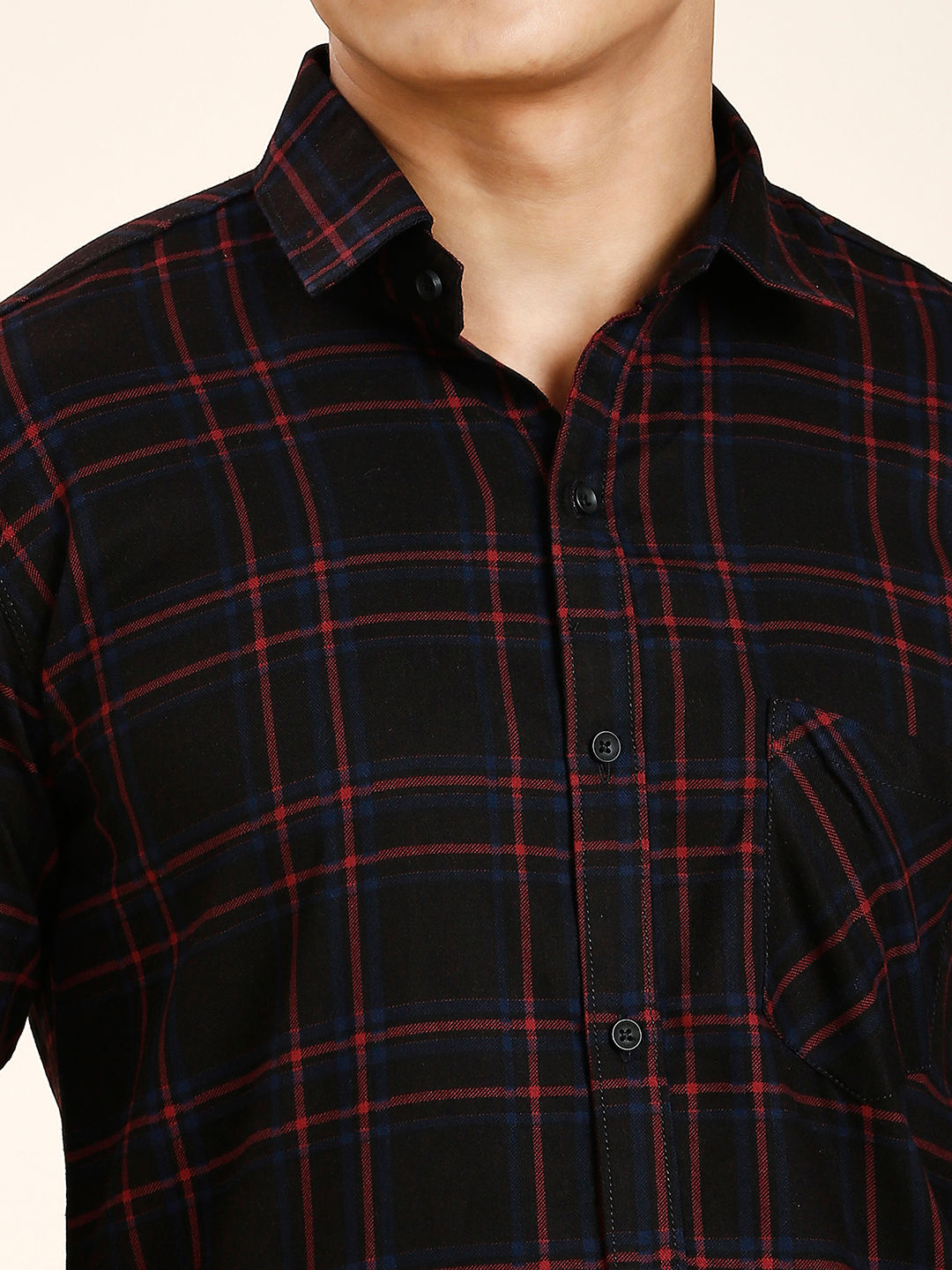 a man wearing a black and red plaid shirt