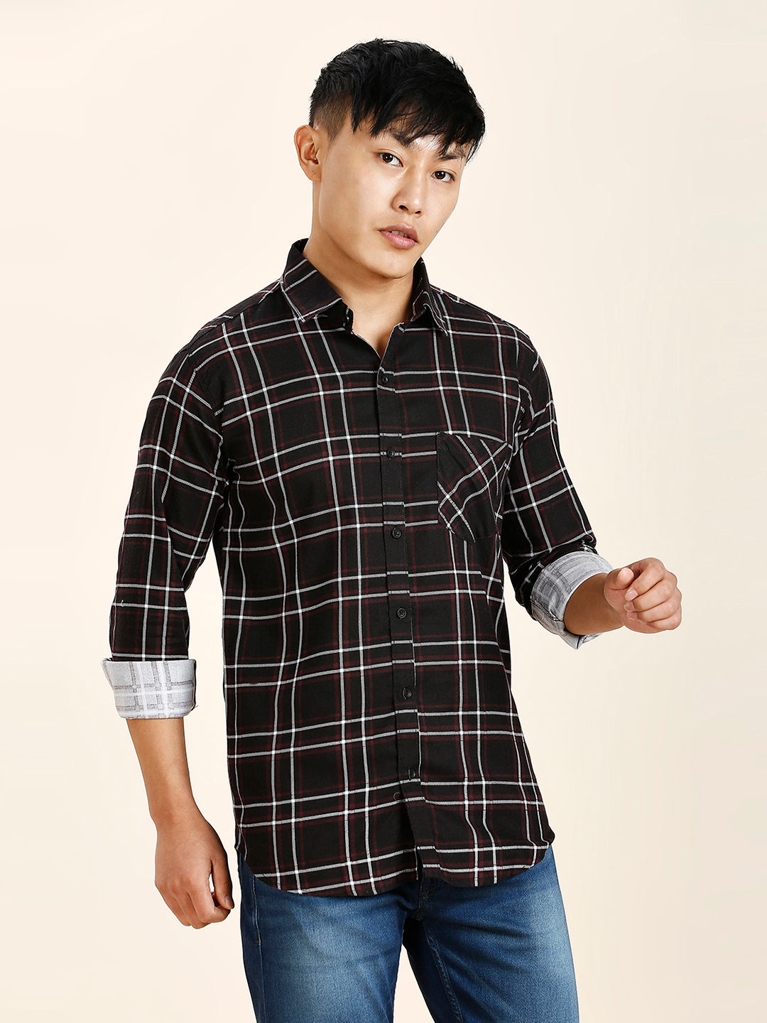 a young man in a black and white checkered shirt