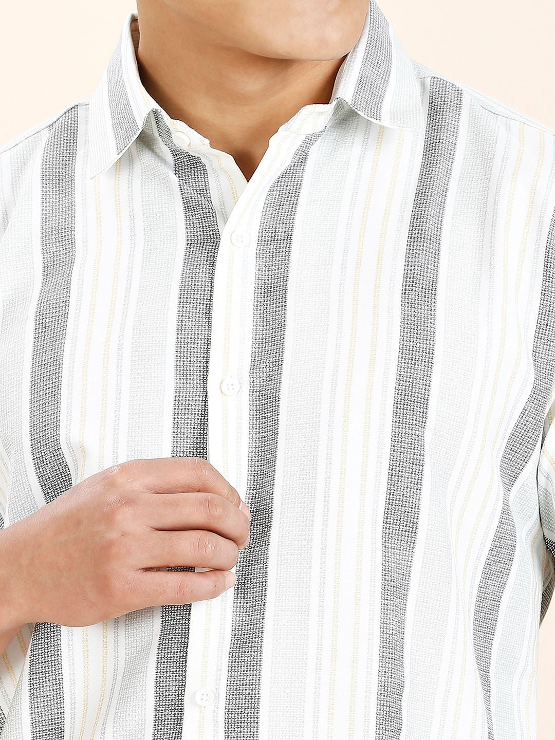 a man wearing a grey and white striped shirt