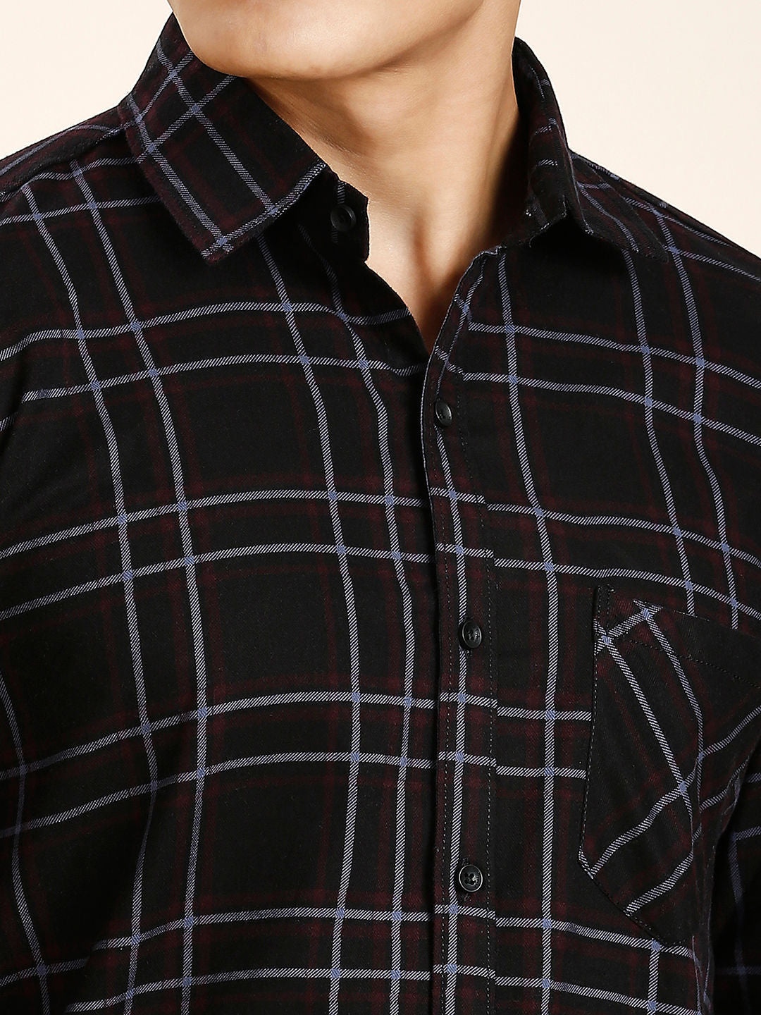 a man wearing a black and grey checkered shirt