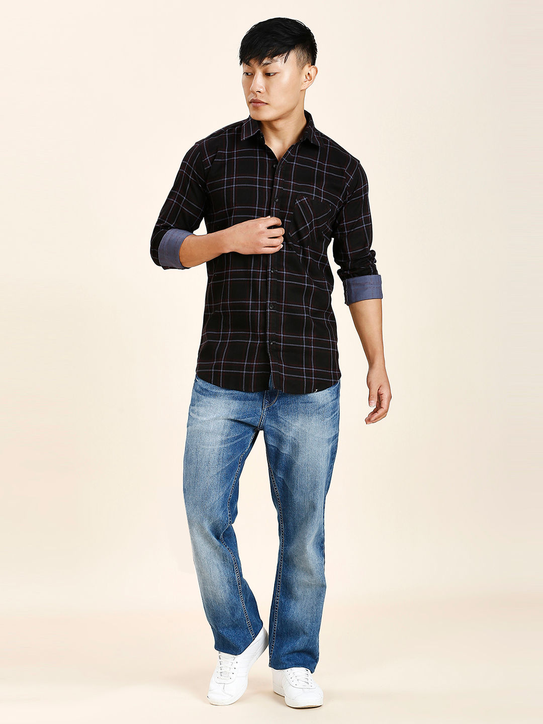 a young man in a black shirt and jeans