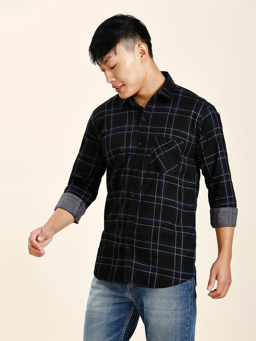 a man in a black and blue plaid shirt