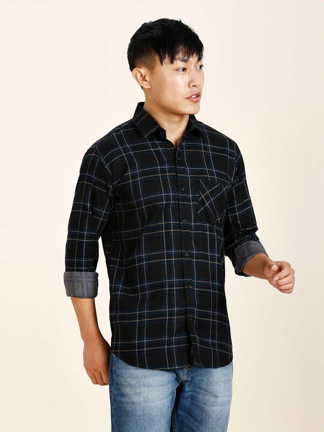 a man in a black and blue plaid shirt