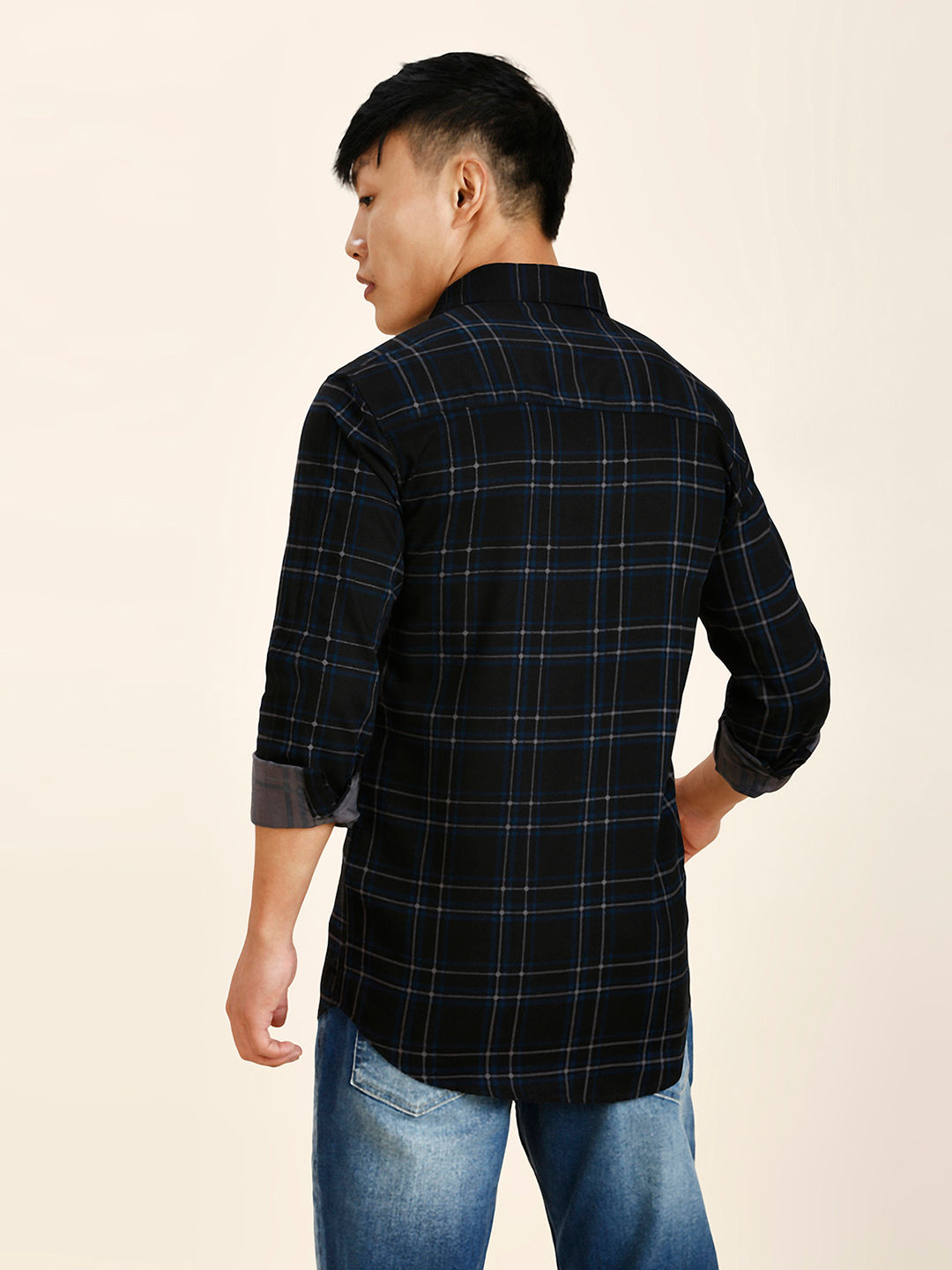 a man in a black and blue plaid shirt