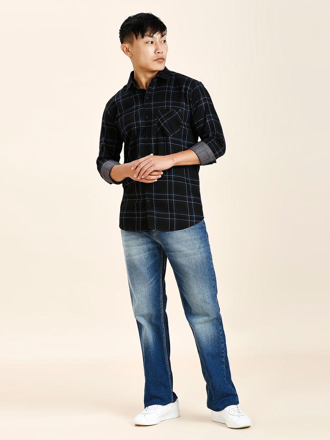 a young man in a black shirt and jeans