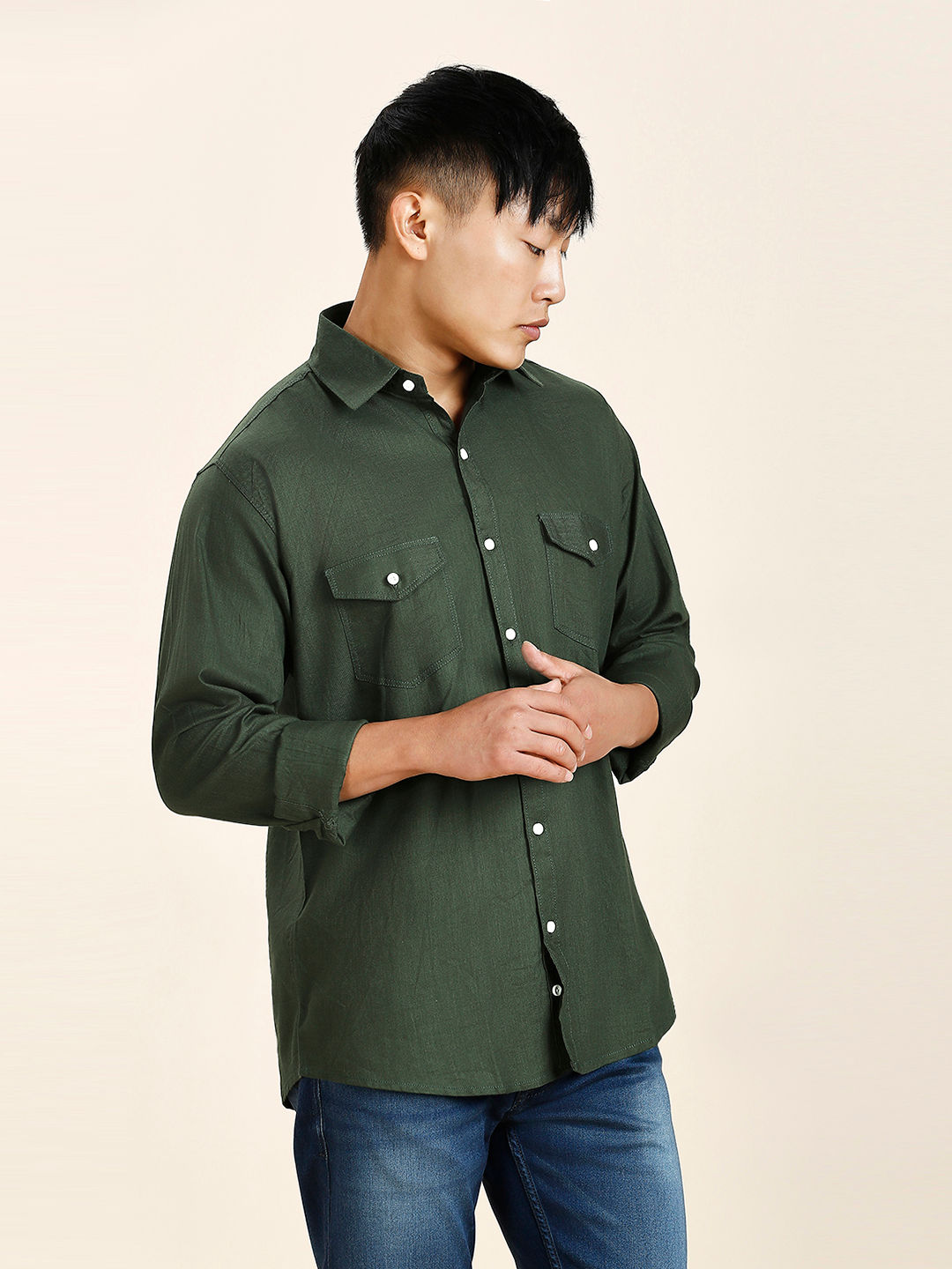 a man in a green shirt is posing for a picture