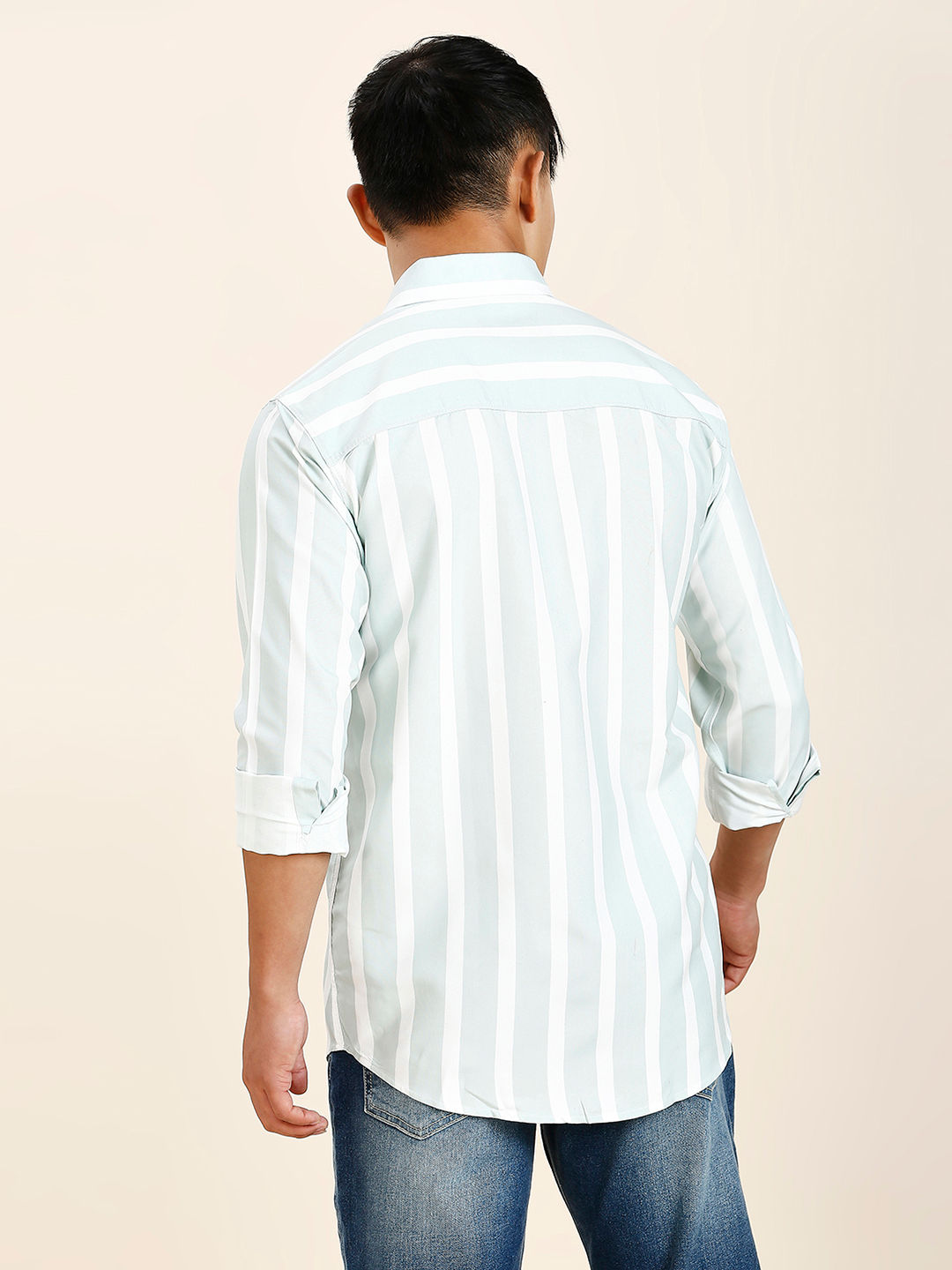 a man in a striped shirt is looking away from the camera