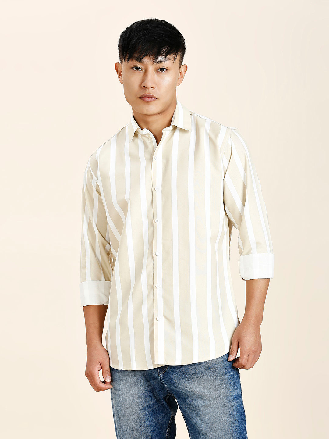 a man in a striped shirt poses for a picture