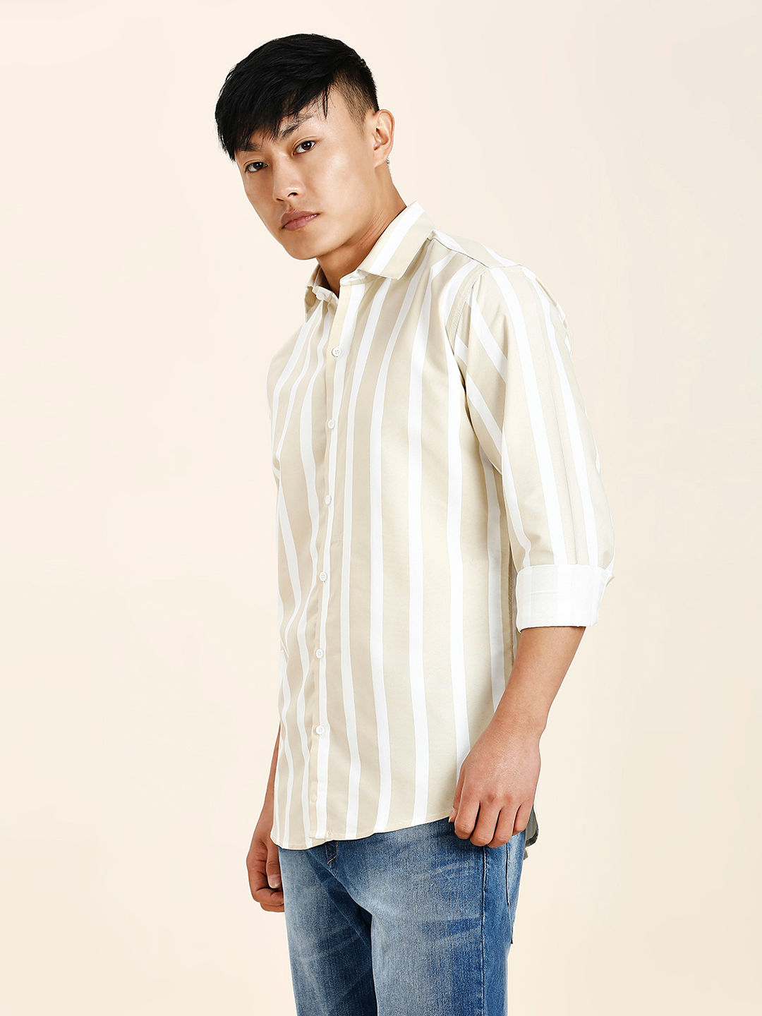 a man in a striped shirt poses for a picture