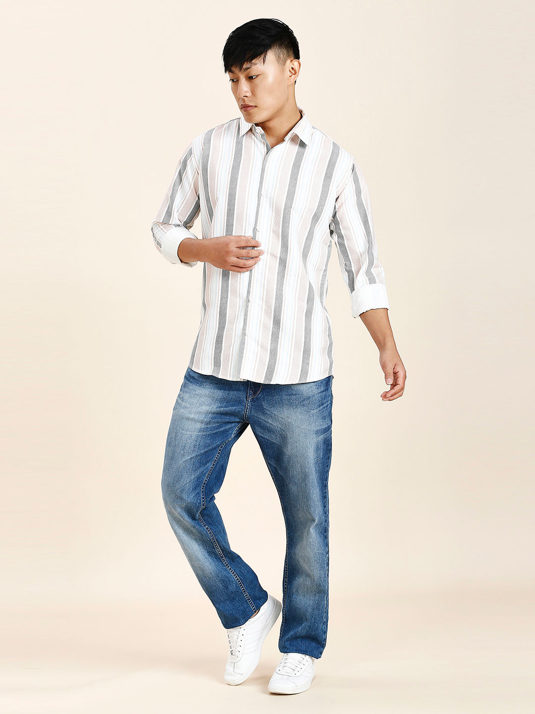 a man in a striped shirt and jeans