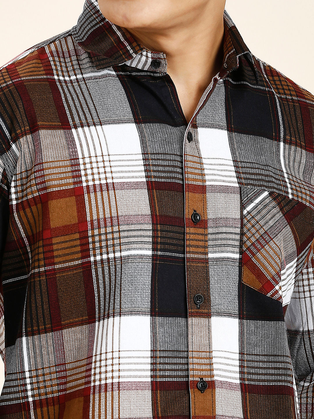 a close up of a person wearing a plaid shirt