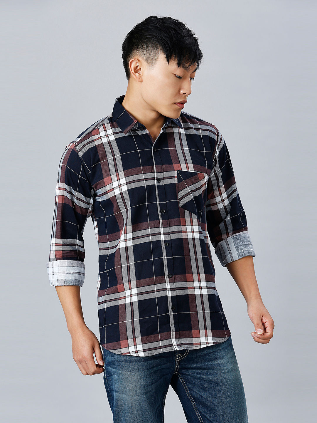 a man wearing a plaid shirt and jeans