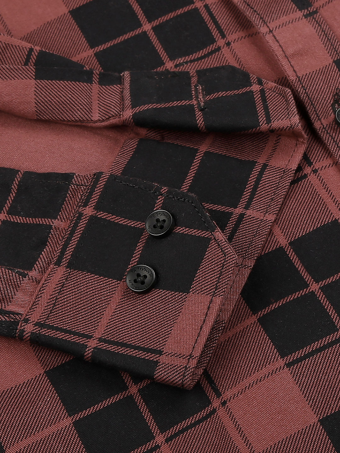 a close up of a red and black plaid shirt